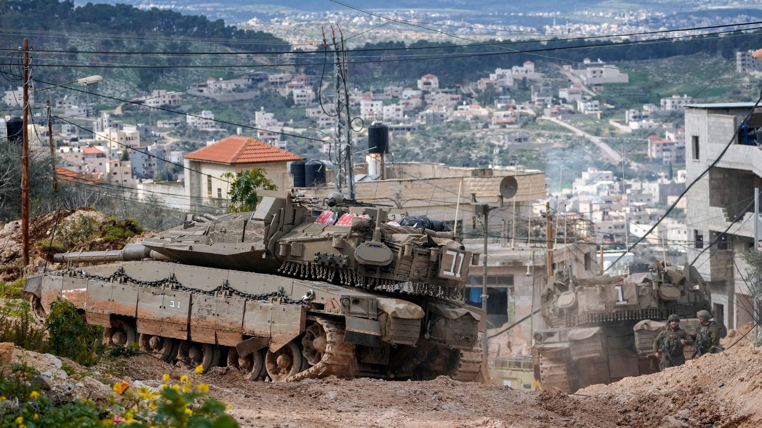 Israeli tanks are deployed during an ongoing army operation in the West Bank Jenin refugee camp, Monday, Feb. 24, 2025. (AP Photo/Majdi Mohammed)