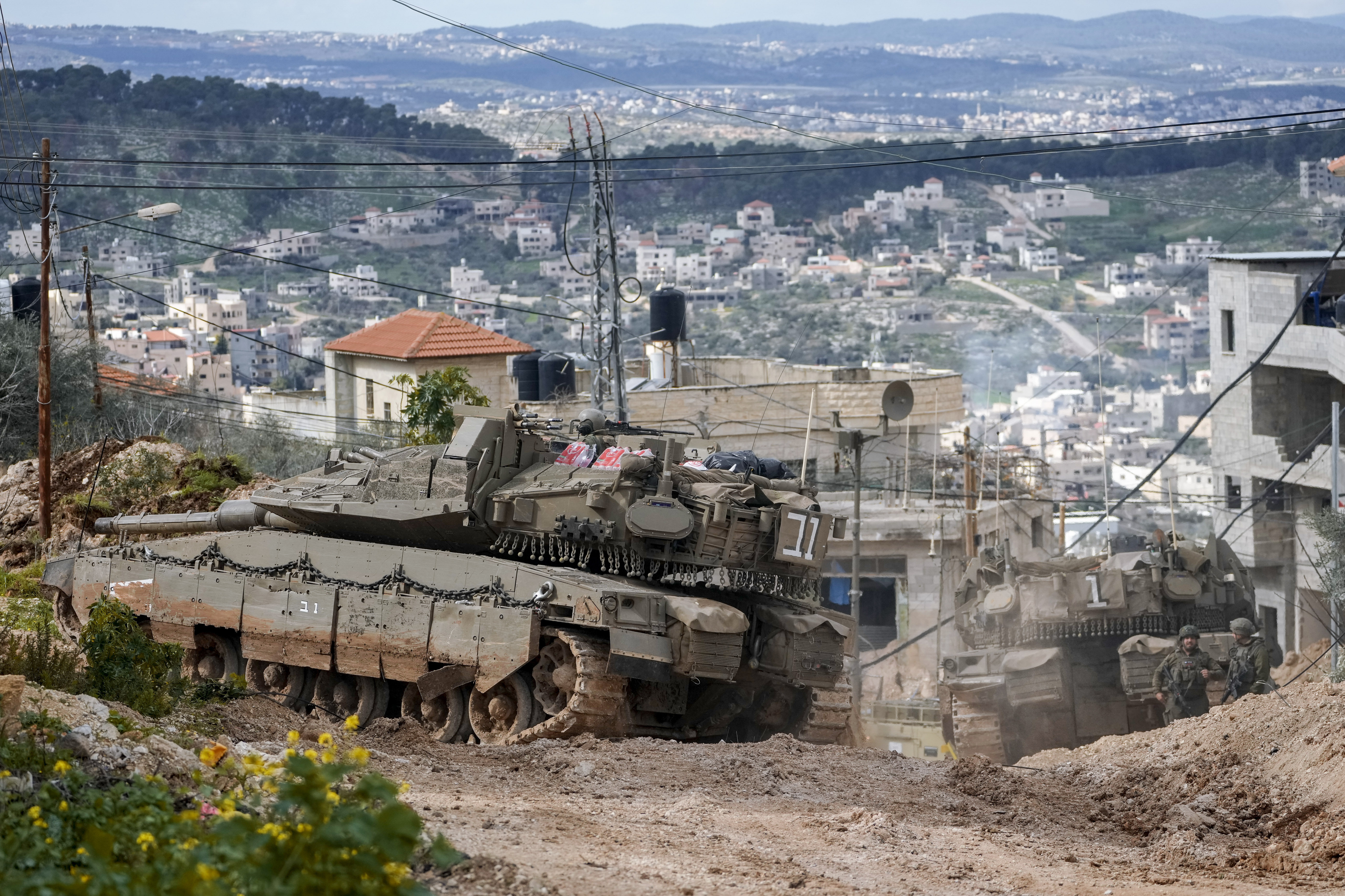 Israeli tanks are deployed during an ongoing army operation in the West Bank Jenin refugee camp, Monday, Feb. 24, 2025. (AP Photo/Majdi Mohammed)