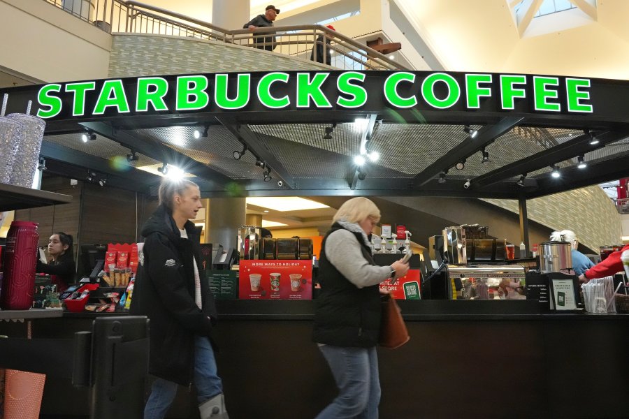 FILE - Shoppers at the Walden Galleria in Buffalo, NY, stop by the Starbucks kiosk on Saturday, Nov. 30, 2024. (AP Photo/Gene J. Puskar, File)