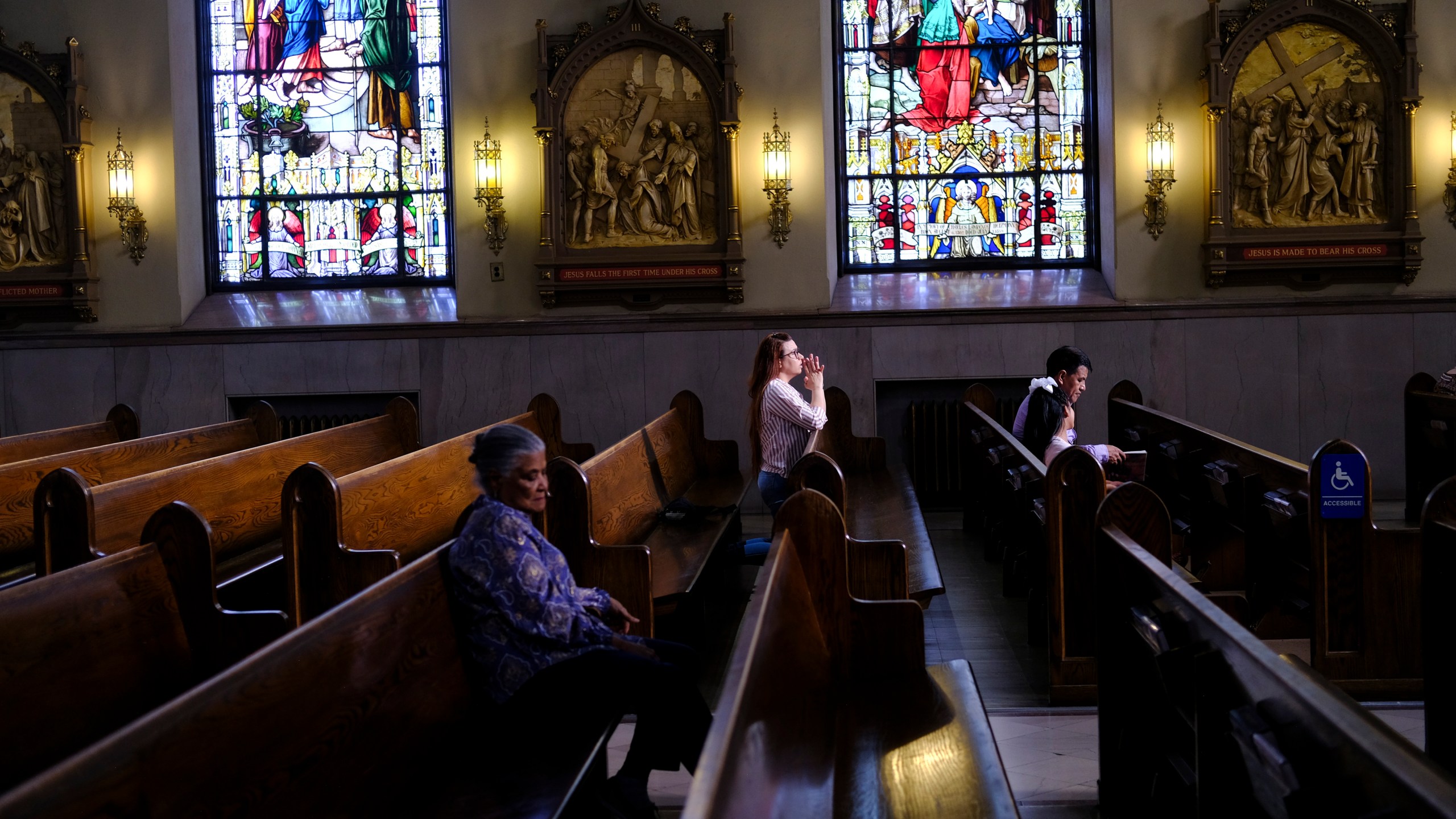 FILE - A parishioner prays at St. Peter the Apostle Catholic Church in Reading, Pa., June 16, 2024. (AP Photo/Luis Andres Henao, File)