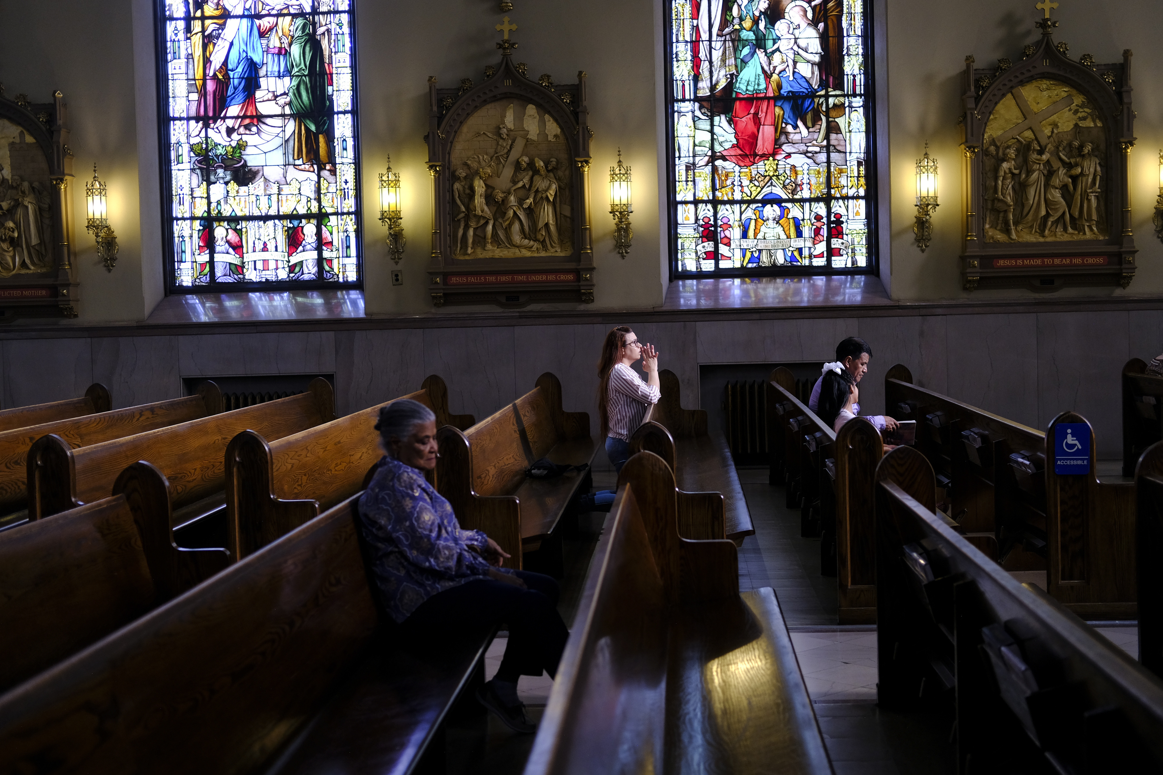 FILE - A parishioner prays at St. Peter the Apostle Catholic Church in Reading, Pa., June 16, 2024. (AP Photo/Luis Andres Henao, File)