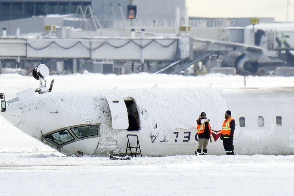 A Delta Air Lines plane lies upside down at Toronto Pearson Airport on Tuesday, Feb. 18, 2025. (Chris Young/The Canadian Press via AP)