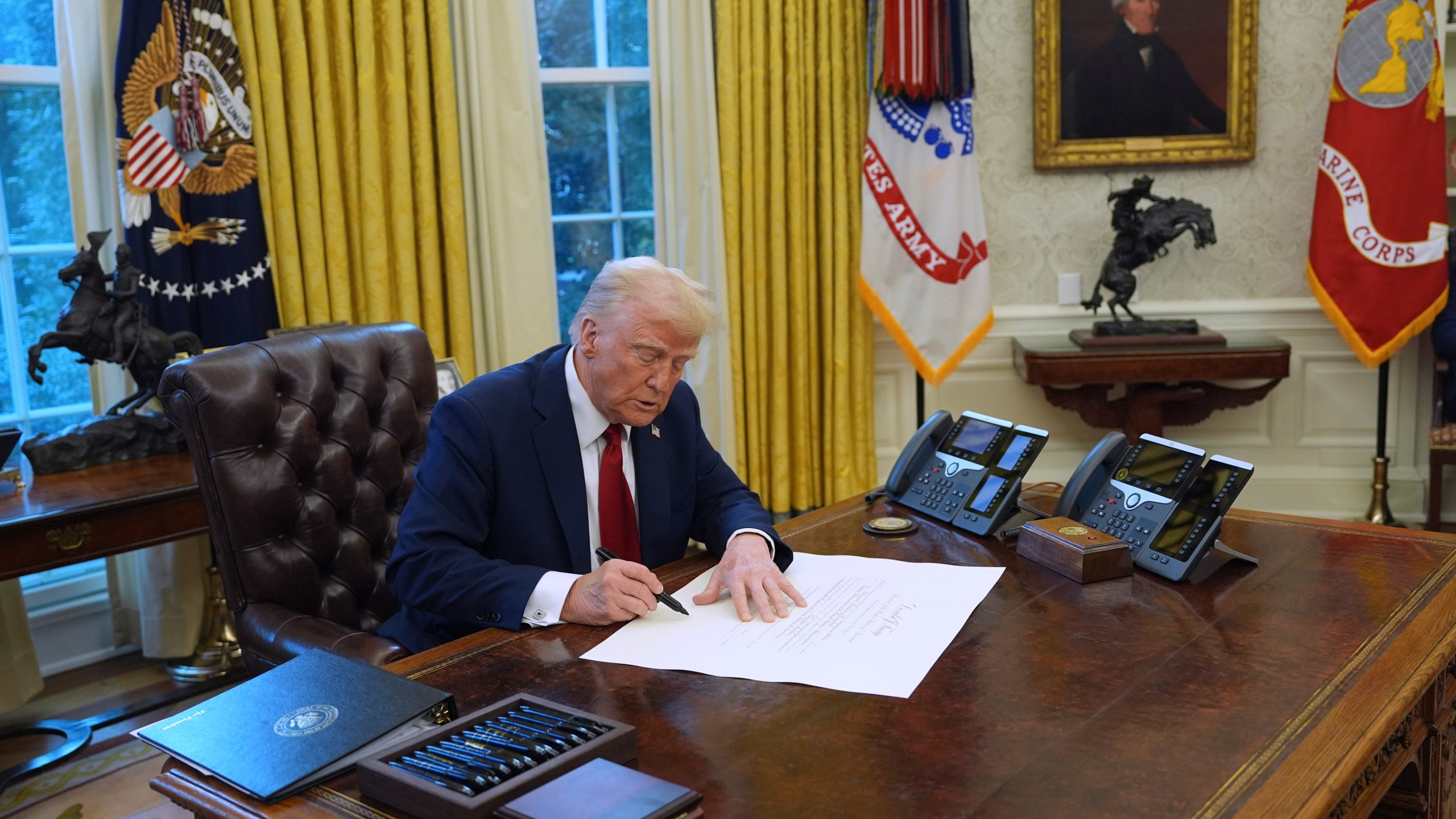 President Donald Trump signs executive orders in the Oval Office at the White House, Thursday, Jan. 30, 2025, in Washington. (AP Photo/Evan Vucci)