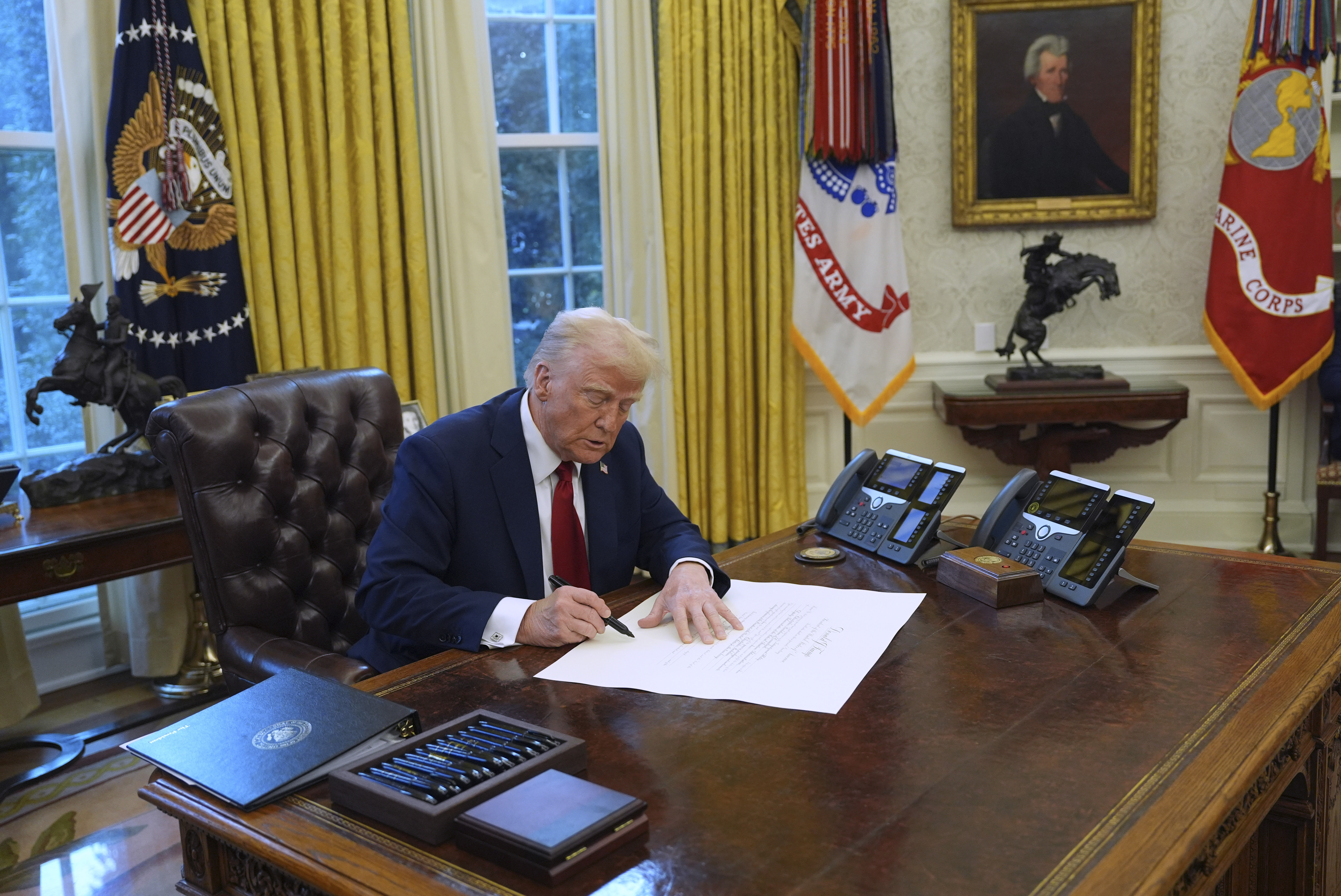 President Donald Trump signs executive orders in the Oval Office at the White House, Thursday, Jan. 30, 2025, in Washington. (AP Photo/Evan Vucci)