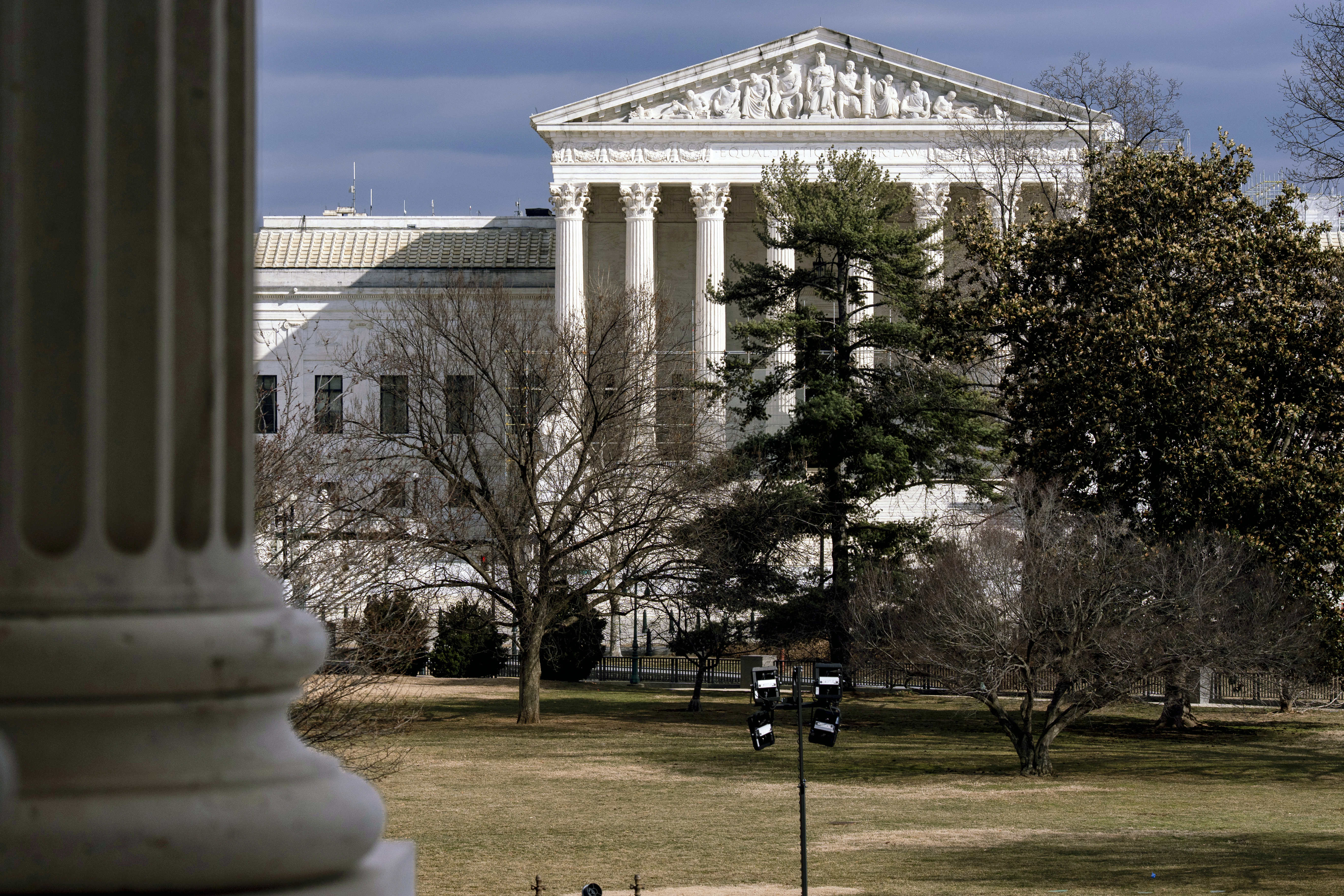 FILE - The Supreme Court is seen in the distance, framed through columns of the U.S. Senate at the Capitol in Washington, Feb. 20, 2025. (AP Photo/J. Scott Applewhite, File)