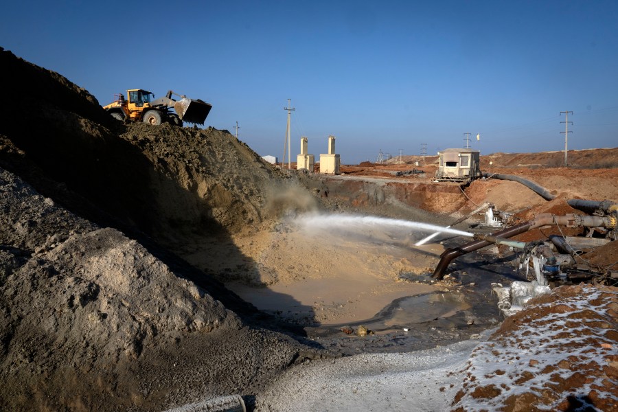 FILE- Miners extract ilmenite, a key element used to produce titanium, at an open pit mine in the central region of Kirovohrad, Ukraine, Feb. 12, 2025. (AP Photo/Efrem Lukatsky, File)