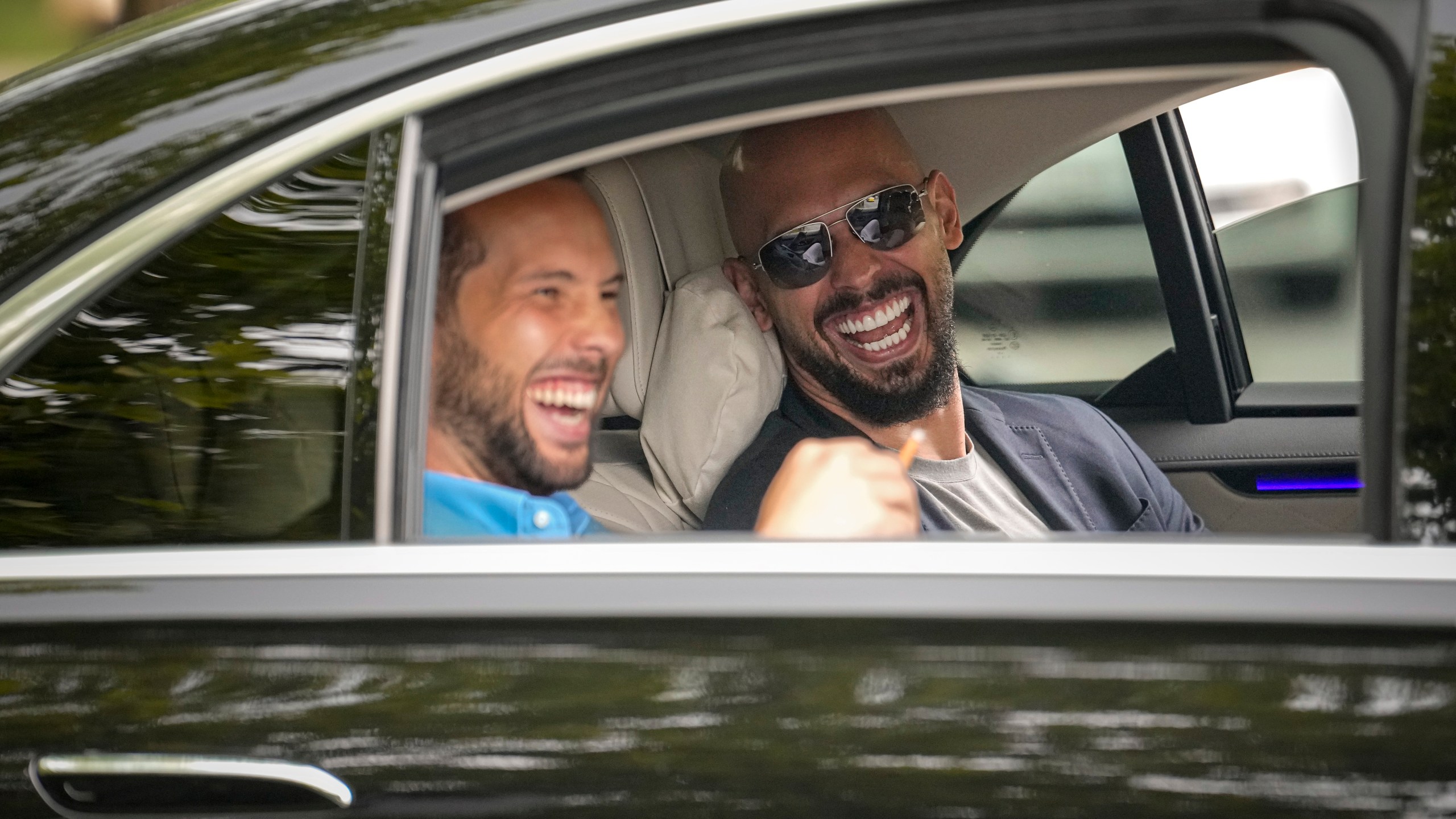 FILE - Andrew Tate, right, and his brother Tristan laugh as they leave the Bucharest Tribunal in Bucharest, Romania, May 8, 2024. (AP Photo/Vadim Ghirda, File)