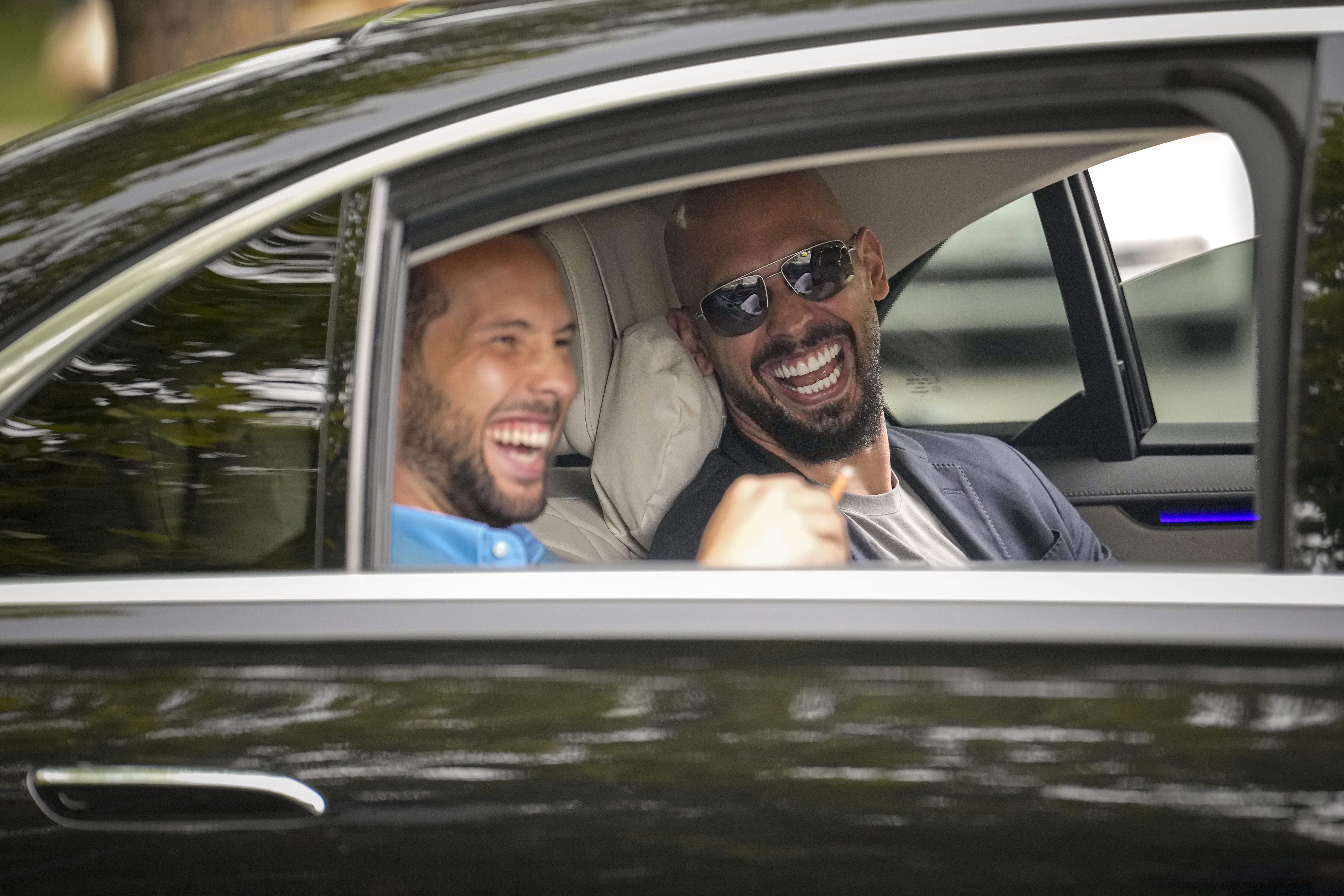 FILE - Andrew Tate, right, and his brother Tristan laugh as they leave the Bucharest Tribunal in Bucharest, Romania, May 8, 2024. (AP Photo/Vadim Ghirda, File)