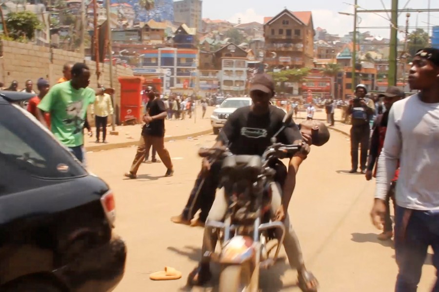 In this video frame grab, people assist victims after two explosions hit a meeting of M23 rebel group leaders and residents in Bukavu, eastern Congo, Thursday, Feb. 27, 2025. (AP Photo/Janvier Barhahiga)