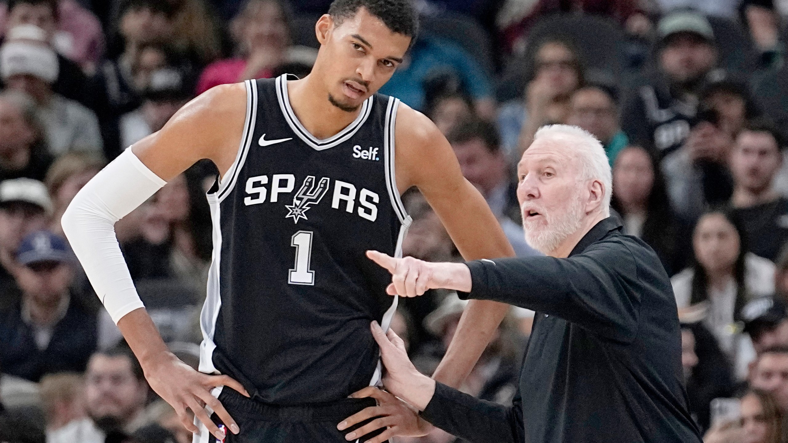 FILE - San Antonio Spurs head coach Gregg Popovich, right, talks with center Victor Wembanyama (1) during the first half of an NBA basketball game against the Los Angeles Lakers in San Antonio, Wednesday, Dec. 13, 2023. (AP Photo/Eric Gay, File)