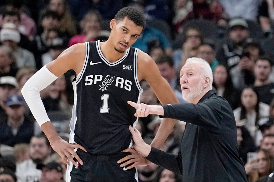 FILE - San Antonio Spurs head coach Gregg Popovich, right, talks with center Victor Wembanyama (1) during the first half of an NBA basketball game against the Los Angeles Lakers in San Antonio, Wednesday, Dec. 13, 2023. (AP Photo/Eric Gay, File)