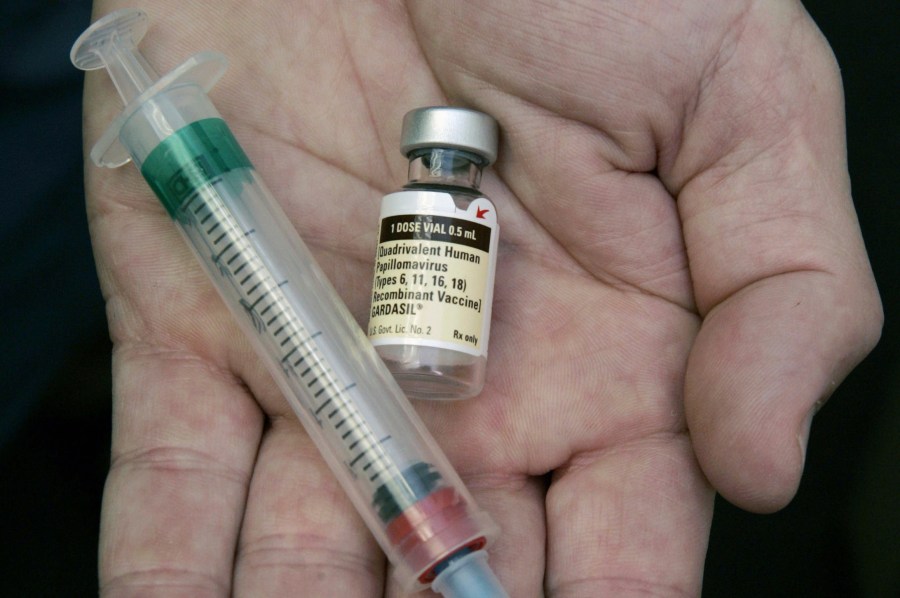 FILE - A doctor holds a vial of the human papillomavirus (HPV) vaccine Gardasil in Chicago on Aug. 28, 2006. (AP Photo/Charles Rex Arbogast, File)