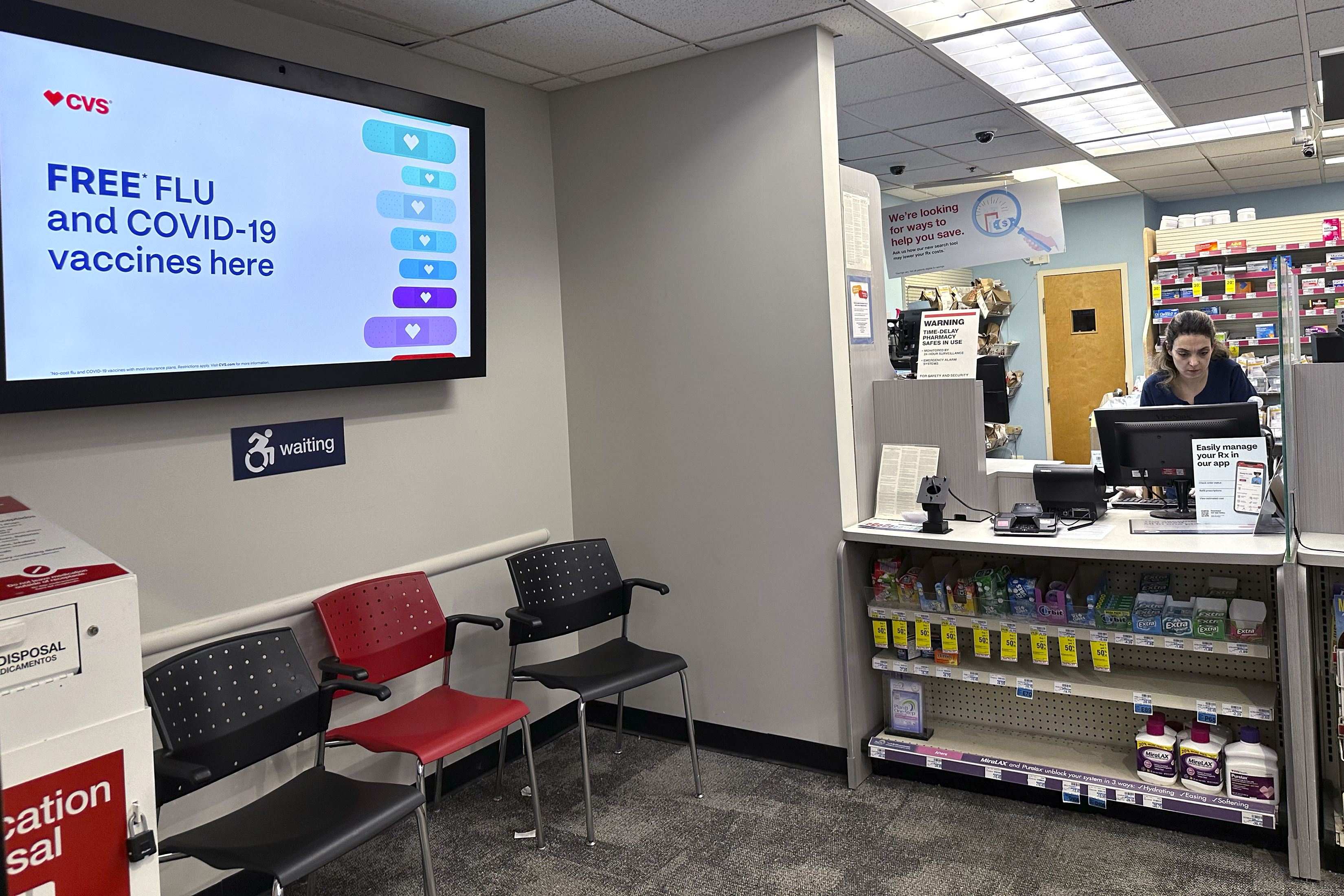 A sign for flu vaccination is displayed on a screen at a pharmacy store in Buffalo Grove, Ill., Tuesday, Feb. 13, 2024. (AP Photo/Nam Y. Huh, File)