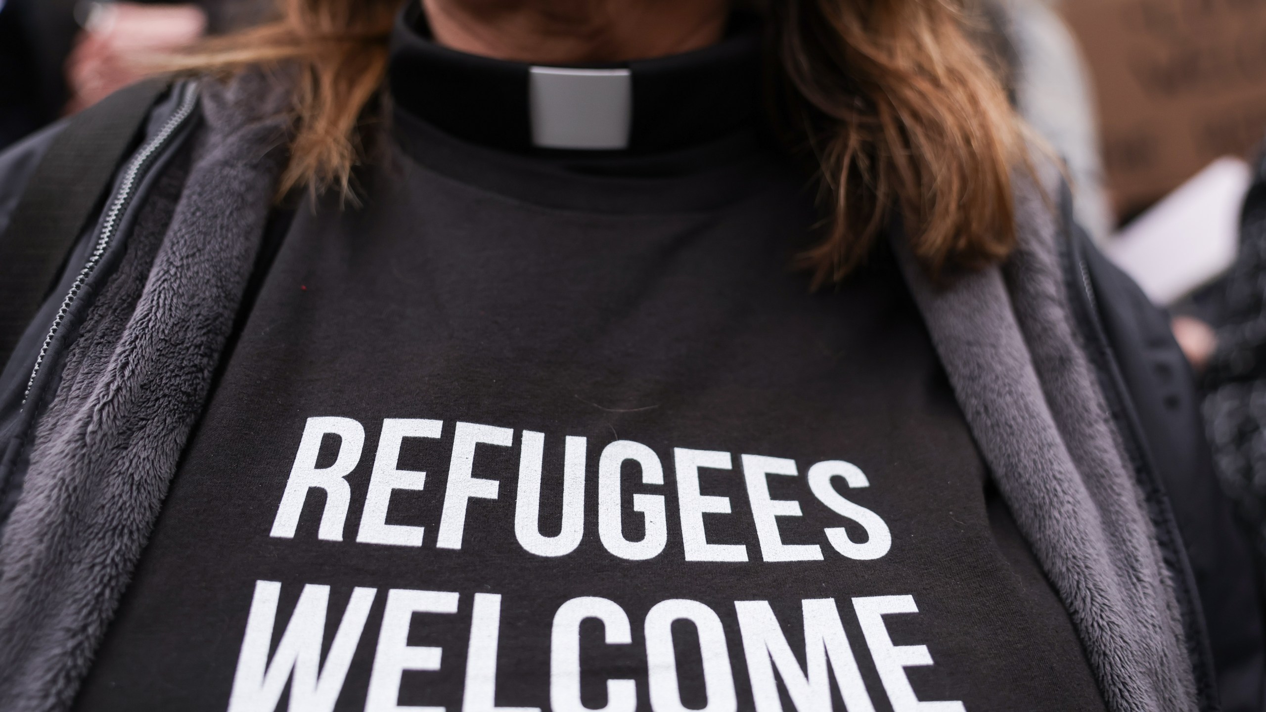 Pastor Jennifer Castle joins others outside the U.S. District Court after a federal judge blocked President Donald Trump's effort to halt the nation's refugee admissions system Tuesday, Feb. 25, 2025, in Seattle. (AP Photo/Ryan Sun)