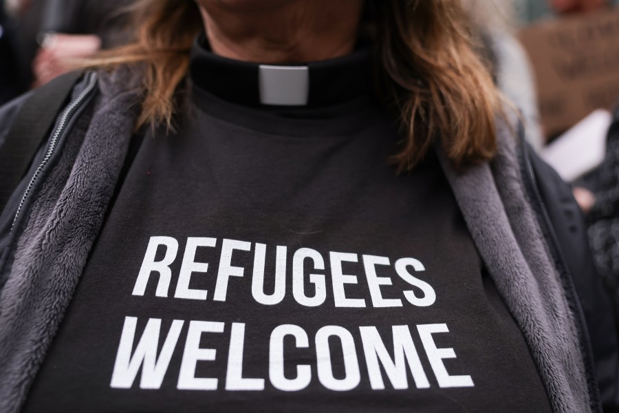 Pastor Jennifer Castle joins others outside the U.S. District Court after a federal judge blocked President Donald Trump's effort to halt the nation's refugee admissions system Tuesday, Feb. 25, 2025, in Seattle. (AP Photo/Ryan Sun)