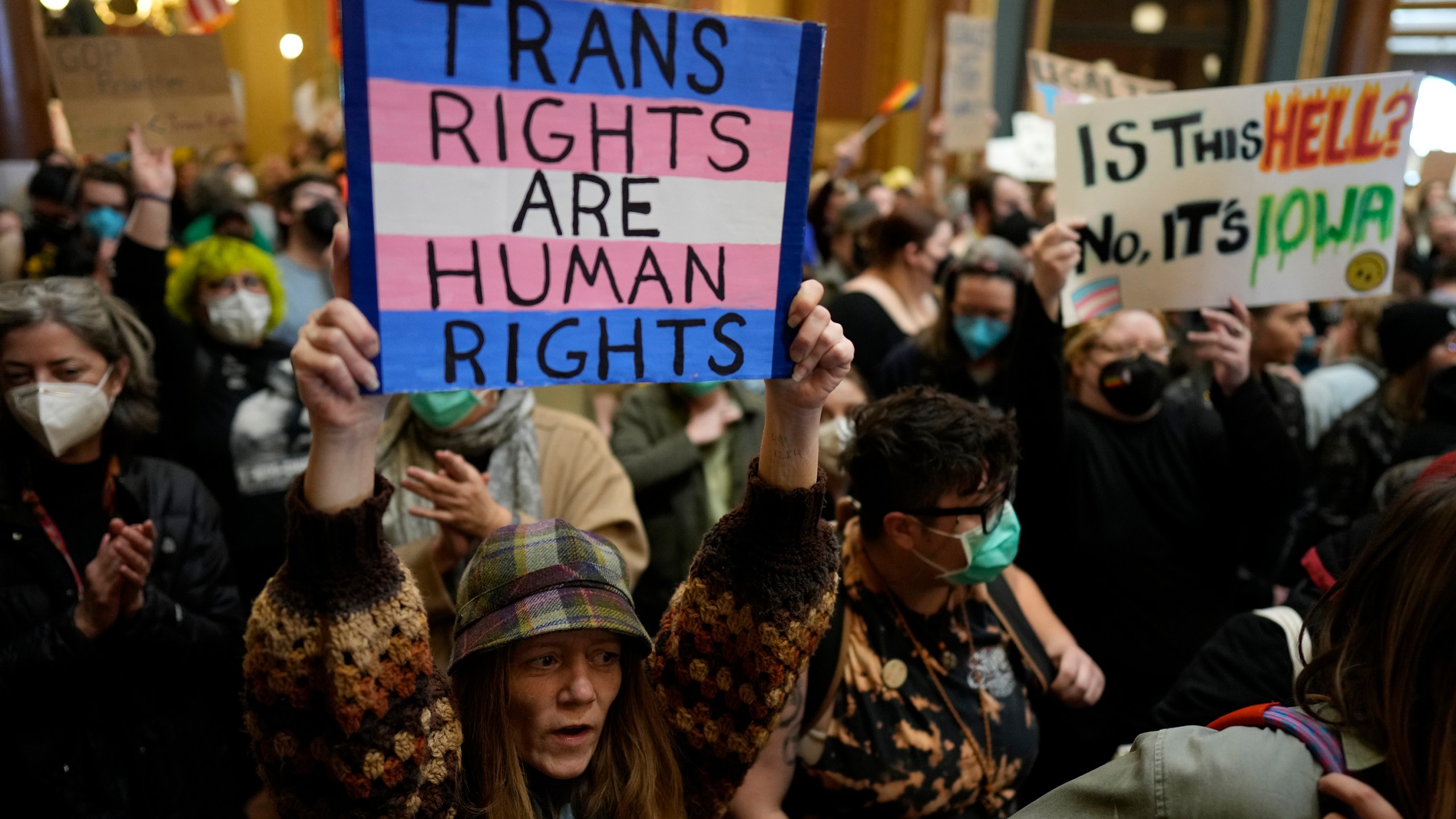 Protesters fill the Iowa state Capitol to denounce a bill that would strip the state civil rights code of protections based on gender identity, Thursday, Feb. 27, 2025, in Des Moines, Iowa. (AP Photo/Charlie Neibergall)