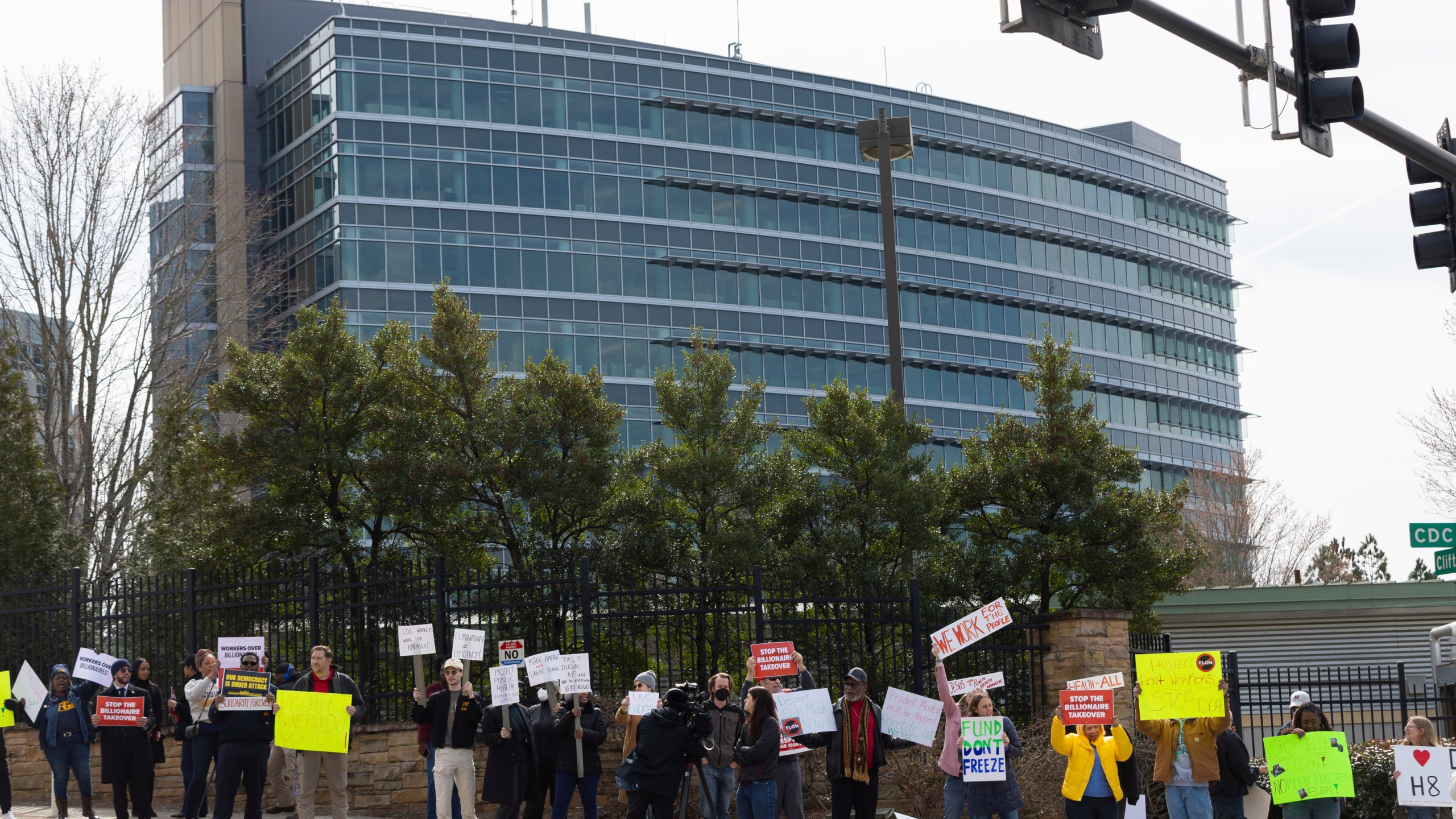 FILE - Demonstrators protest Centers for Disease Control and Prevention (CDC) layoffs in front of the CDC headquarters in Atlanta, Feb. 18, 2025. (Arvin Temkar/Atlanta Journal-Constitution via AP, file)