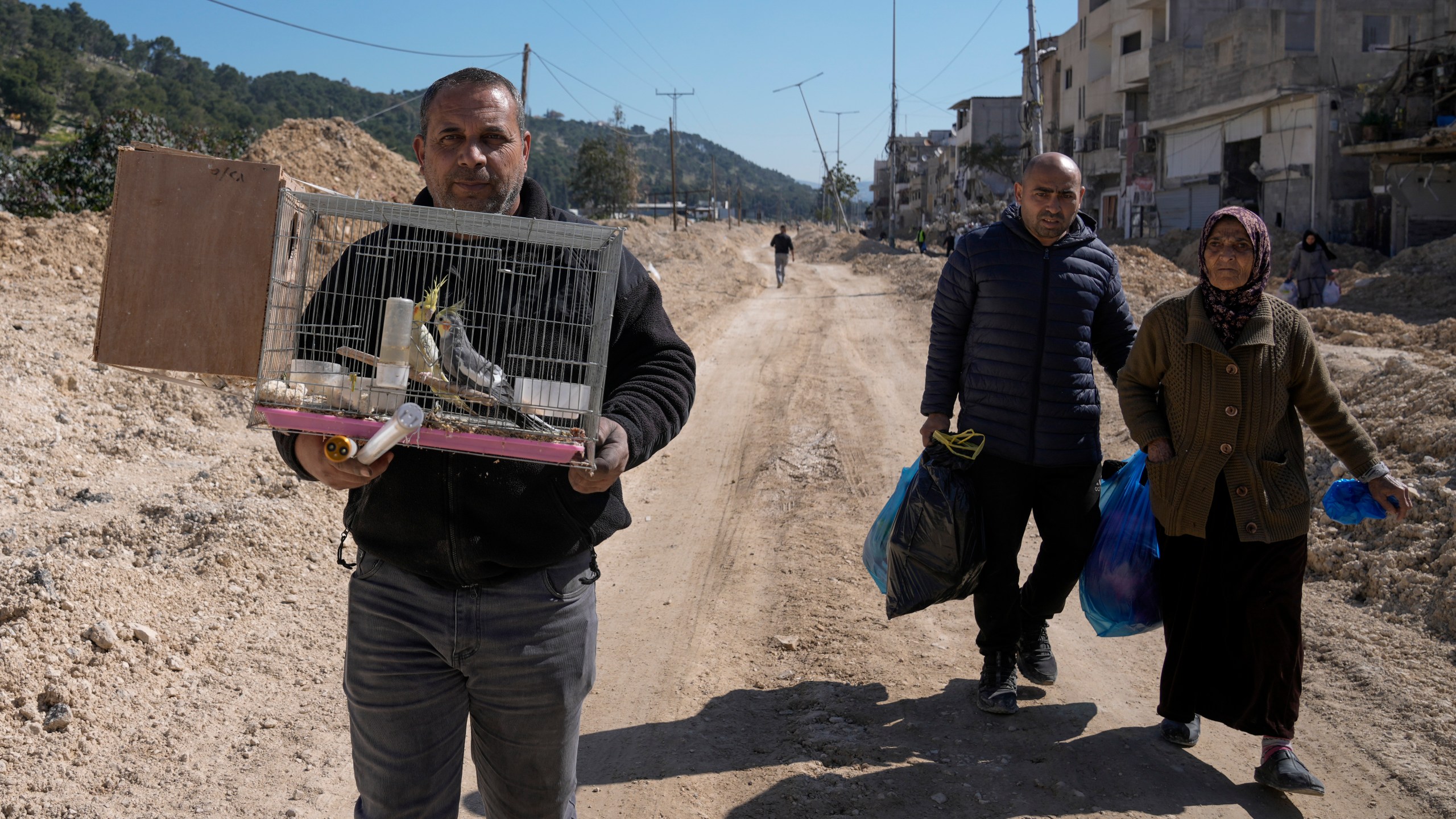 Residents of the West Bank urban refugee camp of Nur Shams evacuate their homes and carry their belongings as the Israeli military continues its operation in the area on Wednesday, Feb. 26, 2025. (AP Photo/Majdi Mohammed)