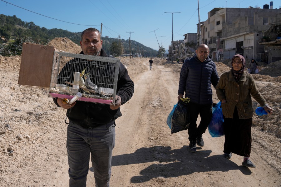 Residents of the West Bank urban refugee camp of Nur Shams evacuate their homes and carry their belongings as the Israeli military continues its operation in the area on Wednesday, Feb. 26, 2025. (AP Photo/Majdi Mohammed)