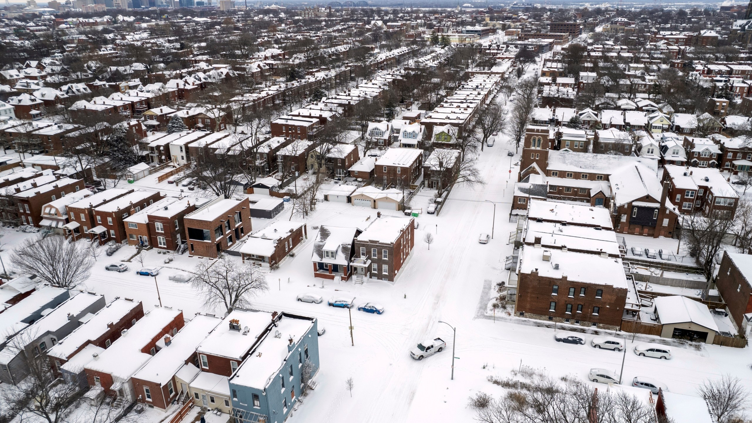 FILE - A pickup truck navigates snow-covered streets following a winter storm, Jan. 6, 2025, in St. Louis. (AP Photo/Jeff Roberson, File)