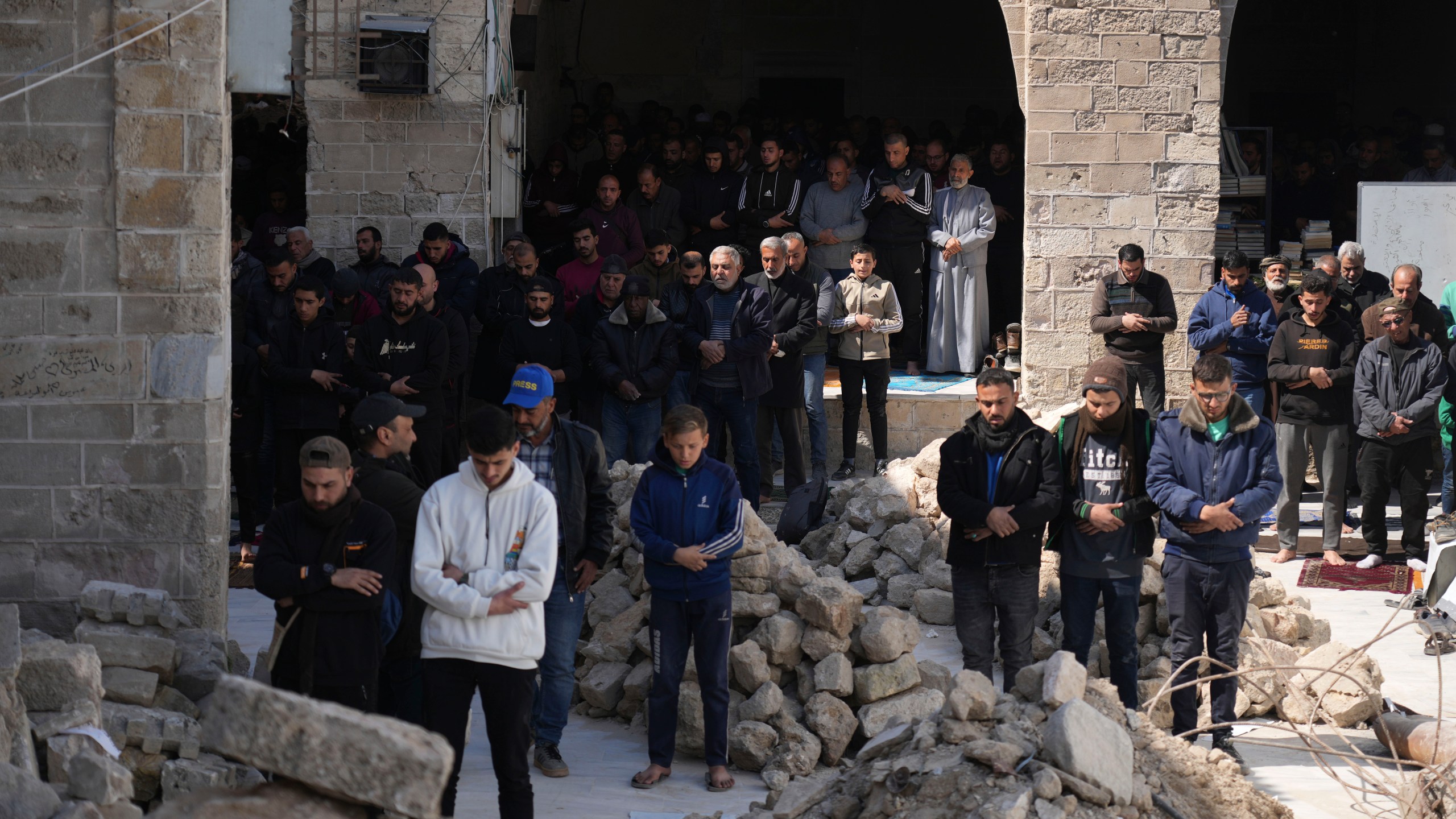 Palestinians take part in Friday prayers in the ruins of the Omari Mosque that was partially destroyed by Israeli bombardment, ahead of the start of the Muslim holy month of Ramadan in Gaza City, Gaza Strip, Friday, Feb. 28, 2025. (AP Photo/Abdel Kareem Hana)