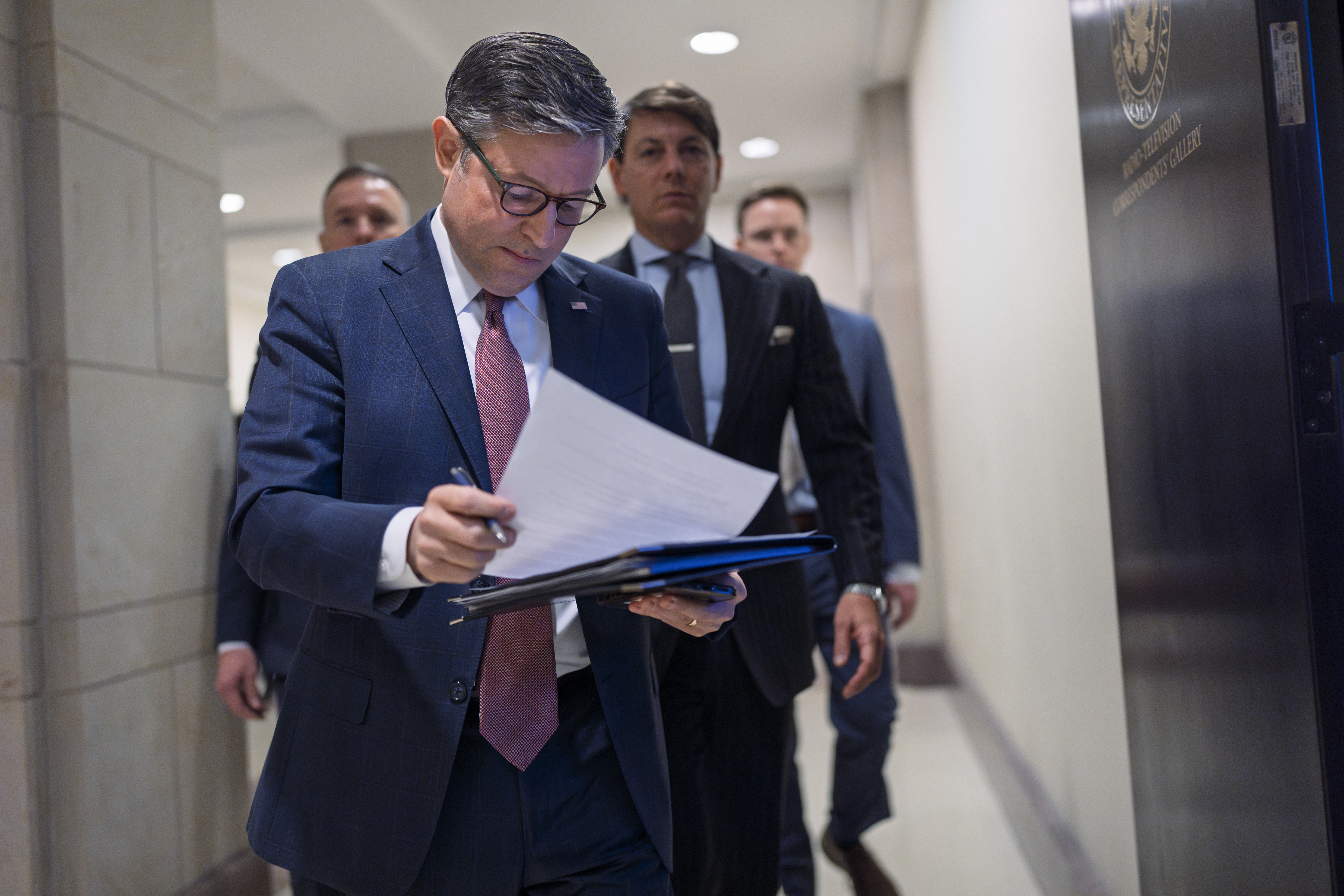 Speaker of the House Mike Johnson, R-La., arrives to talk to reporters after a closed-door meeting with fellow Republicans to find agreement on a spending bill, at the Capitol in Washington, Tuesday, Feb. 11, 2025. (AP Photo/J. Scott Applewhite)