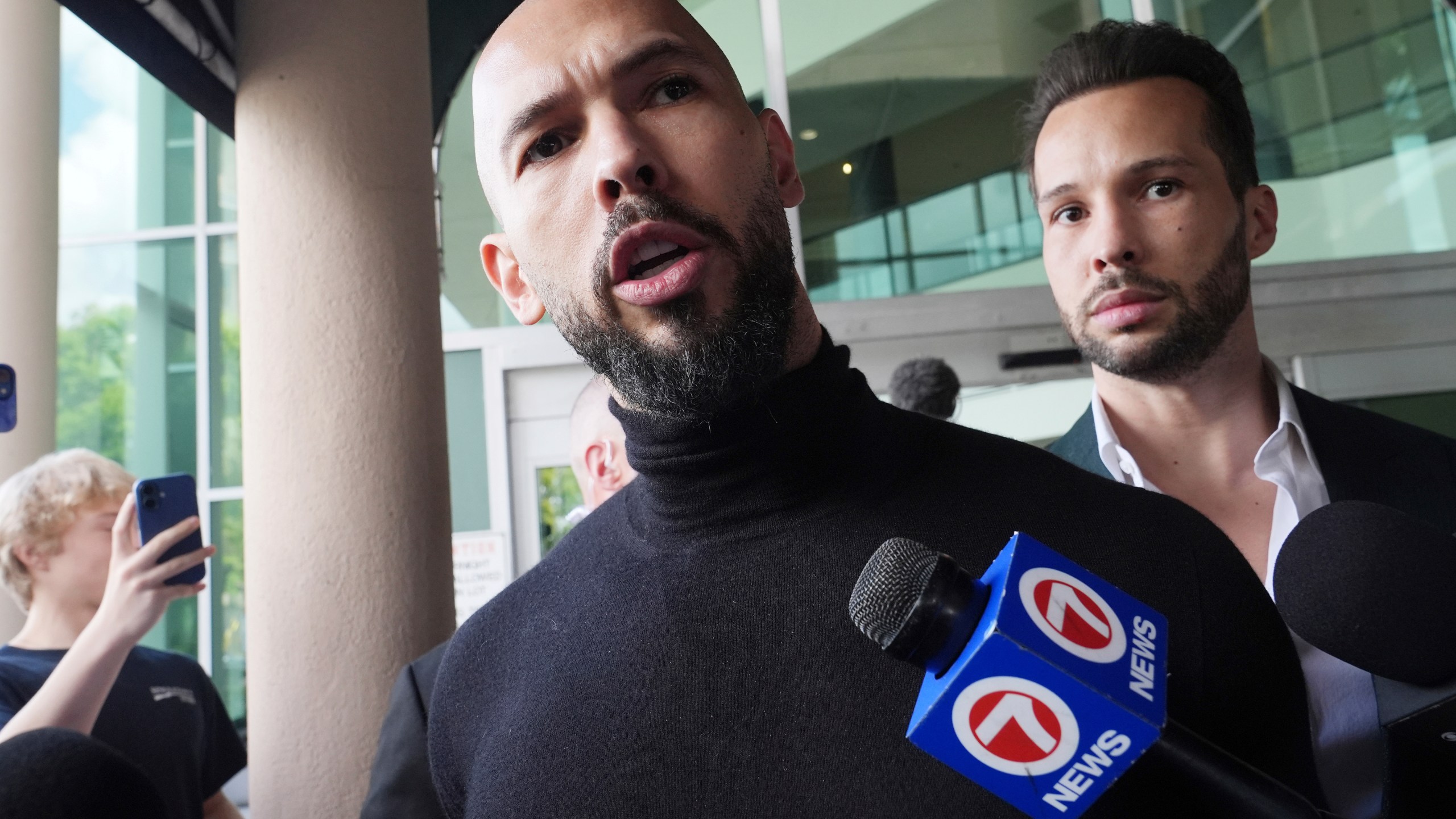 Influencer brothers Andrew and Tristan Tate arrive, Thursday, Feb. 27, 2025, in Fort Lauderdale, Fla. The brothers were charged with human trafficking in Romania and arrived in the U.S. after authorities lifted travel restrictions. (AP Photo/Marta Lavandier)