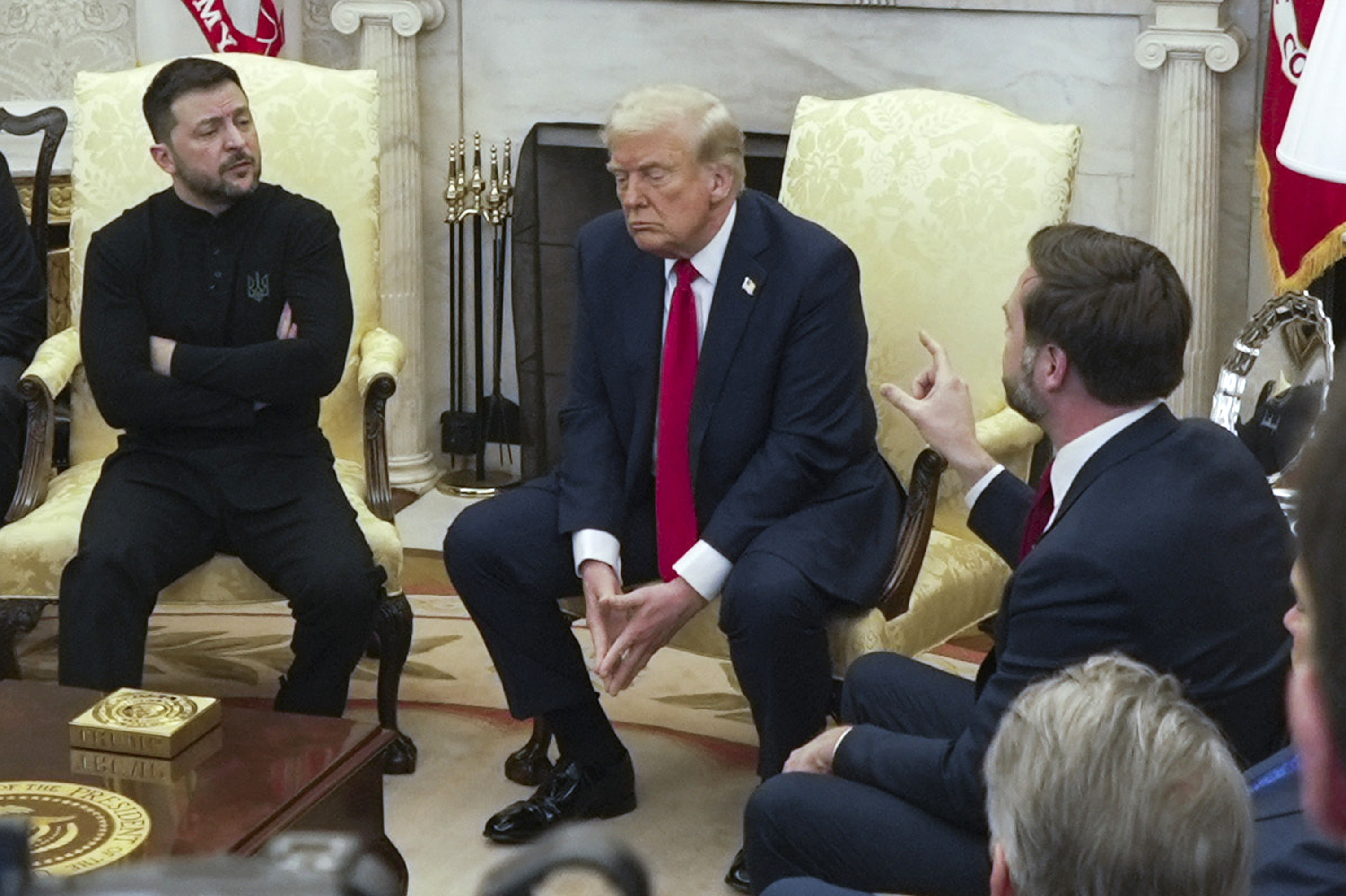 Vice President JD Vance, right, speaks with Ukrainian President Volodymyr Zelenskyy, left, as President Donald Trump listens in the Oval Office at the White House, Friday, Feb. 28, 2025, in Washington. (AP Photo/ Mystyslav Chernov)