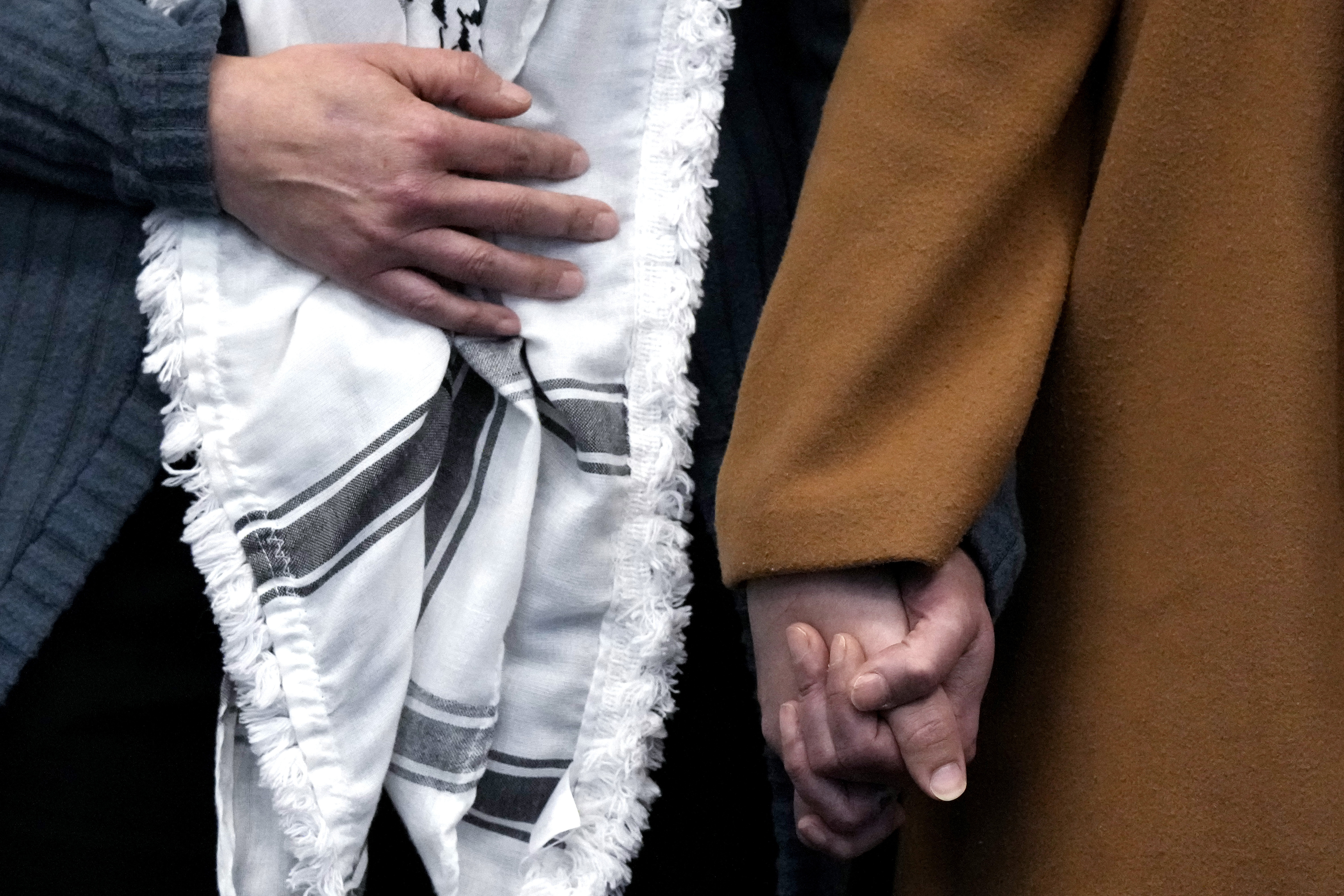 Hela Yousef, right, cousin of 6-year-old Palestinian boy Wadee Alfayoumi, holds hands with the mother of the boy's friend during a news conference at the Will County Courthouse where a jury found defendant Joseph Czuba found guilty of murder and hate crime charges, Friday, Feb. 28, 2025, in Joliet, Ill. (AP Photo/Nam Y. Huh)