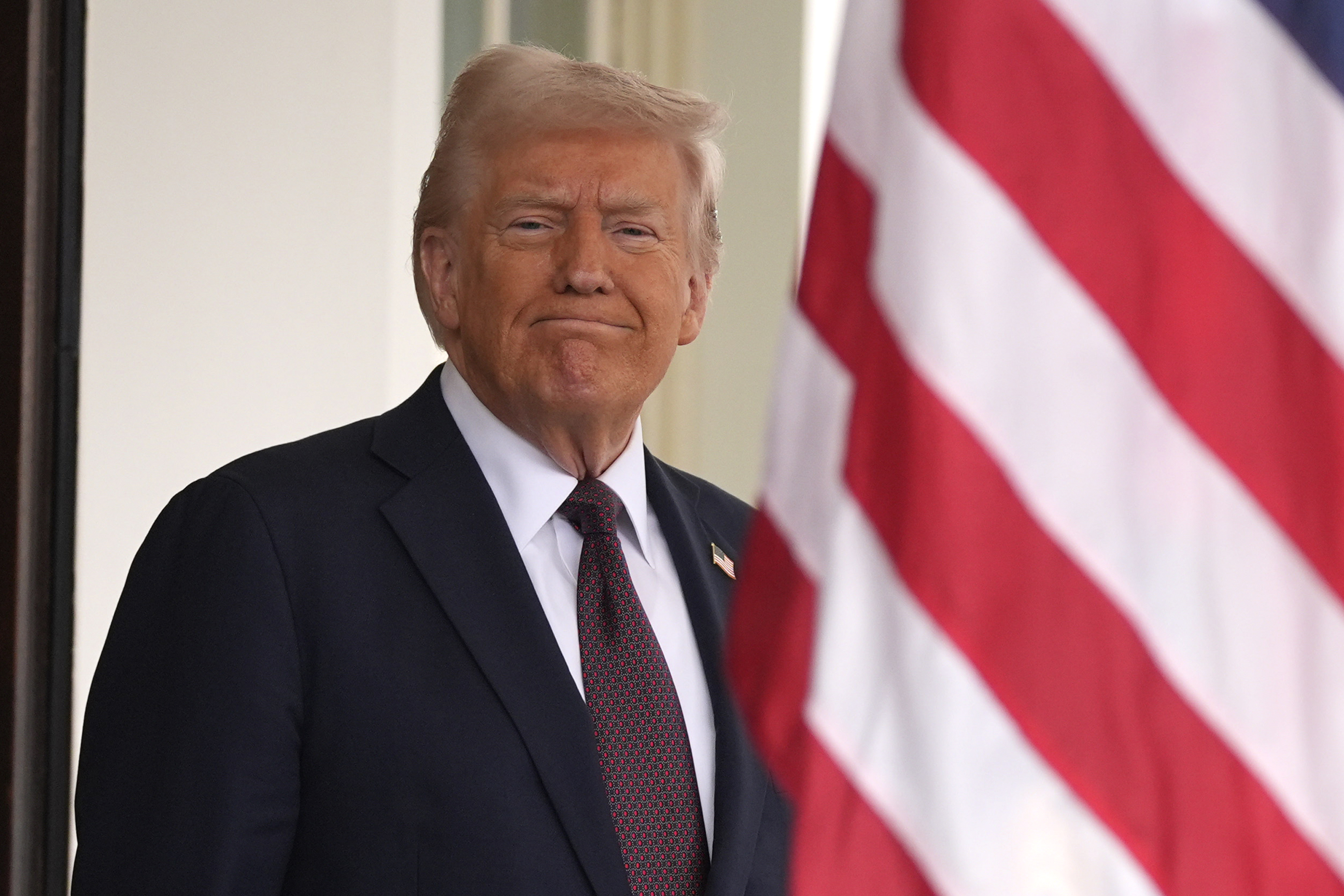 President Donald Trump stands before British Prime Minister Keir Starmer arrives at the White House, Thursday, Feb. 27, 2025, in Washington. (AP Photo/Evan Vucci)