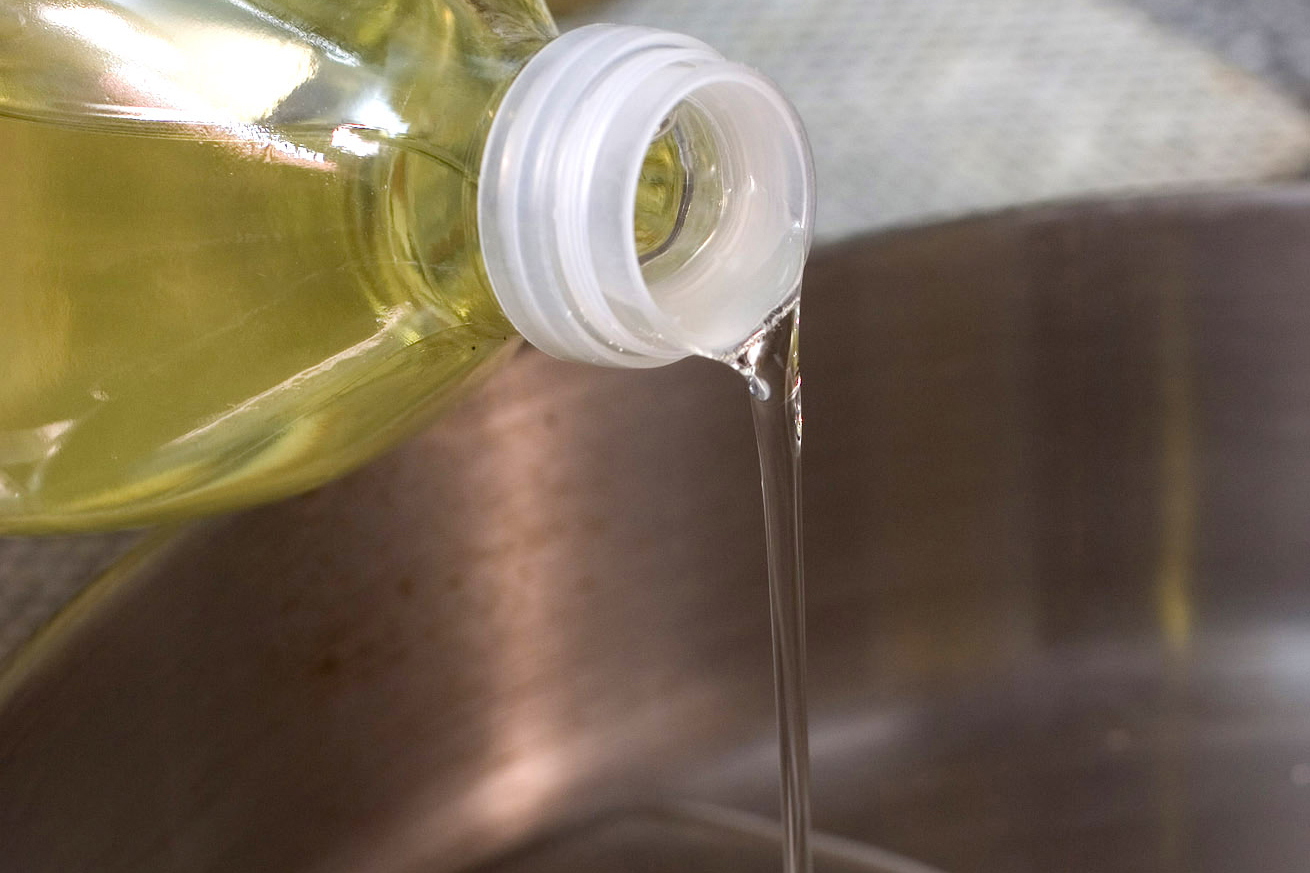 FILE - Canola oil is poured into a pan in Concord, N.H., on March 27, 2007. (AP Photo/Larry Crowe, File)