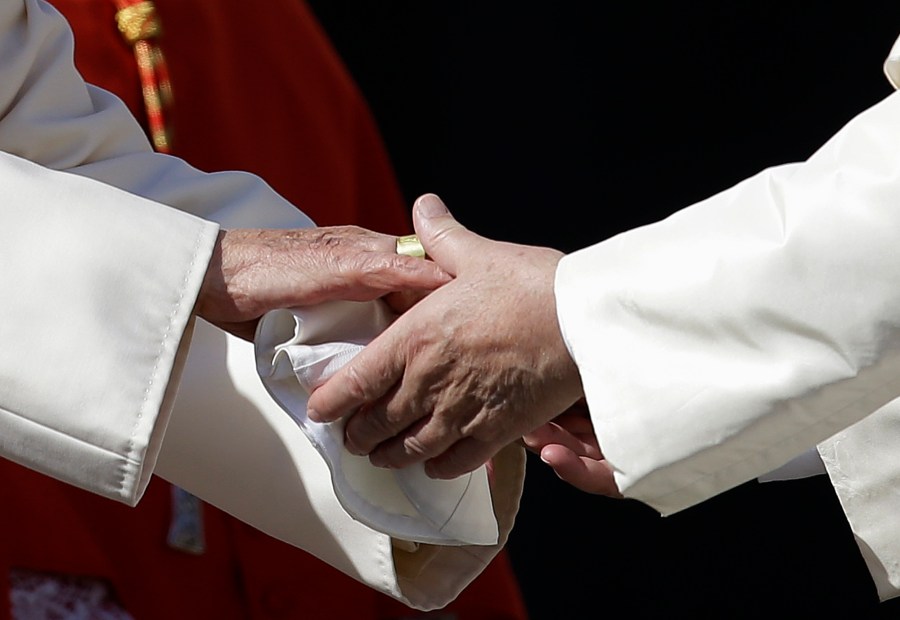 Pope Francis, right, greets Pope Emeritus Benedict XVI at the end of a meeting with elderly faithful in St. Peter's Square at the Vatican, on Sept. 28, 2014. (AP Photo/Gregorio Borgia, File)