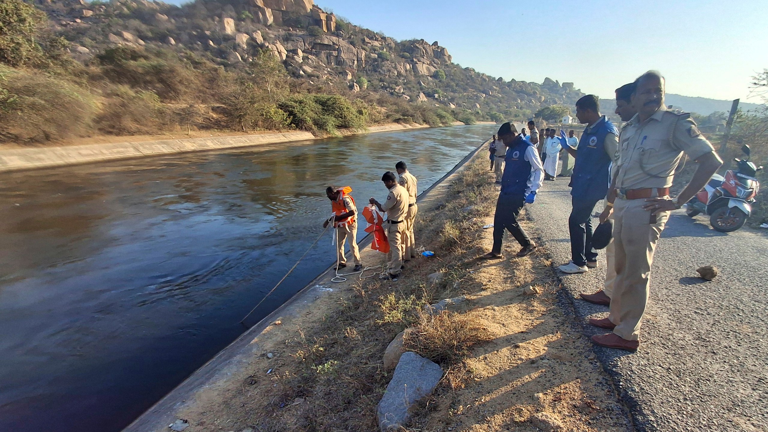 Police officials search for the male travelers who were pushed into the canal by three men accused of gang-raping two women, in Koppal district of southern state of Karnataka, India, Friday, March 7, 2025. (AP Photo)