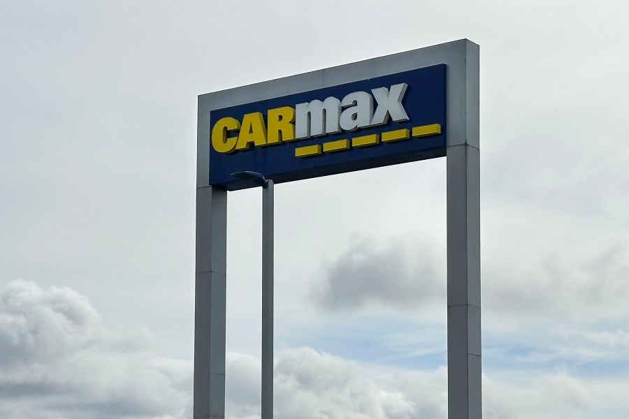 FILE - A CarMax sign stands at a location in Colma, Calif., March 4, 2024. (AP Photo/Jeff Chiu, File)