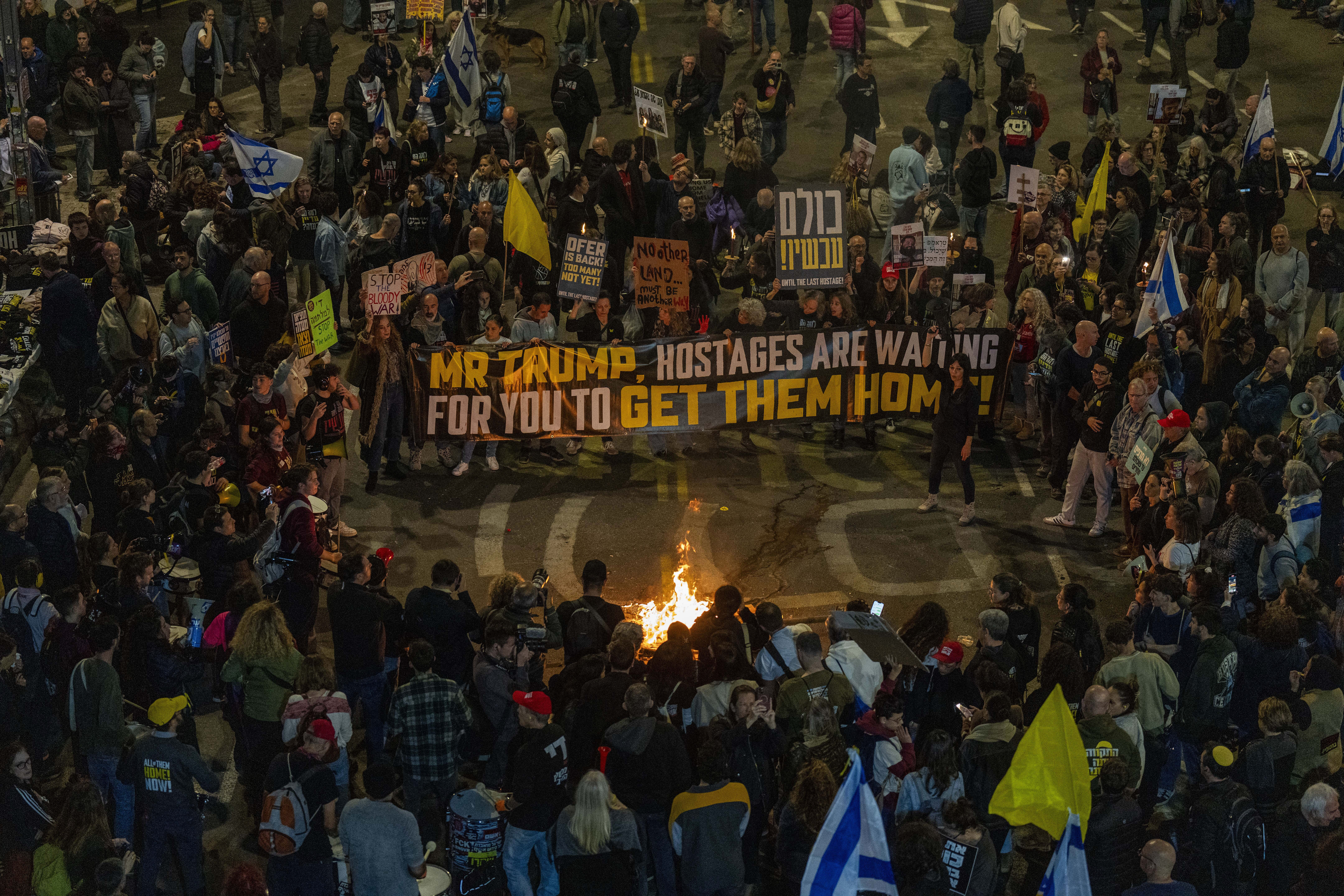 People take part in a protest in Tel Aviv, Israel, Saturday, March 8, 2025, demanding the immediate release of hostages held by Hamas in the Gaza Strip. (AP Photo/Ariel Schalit)