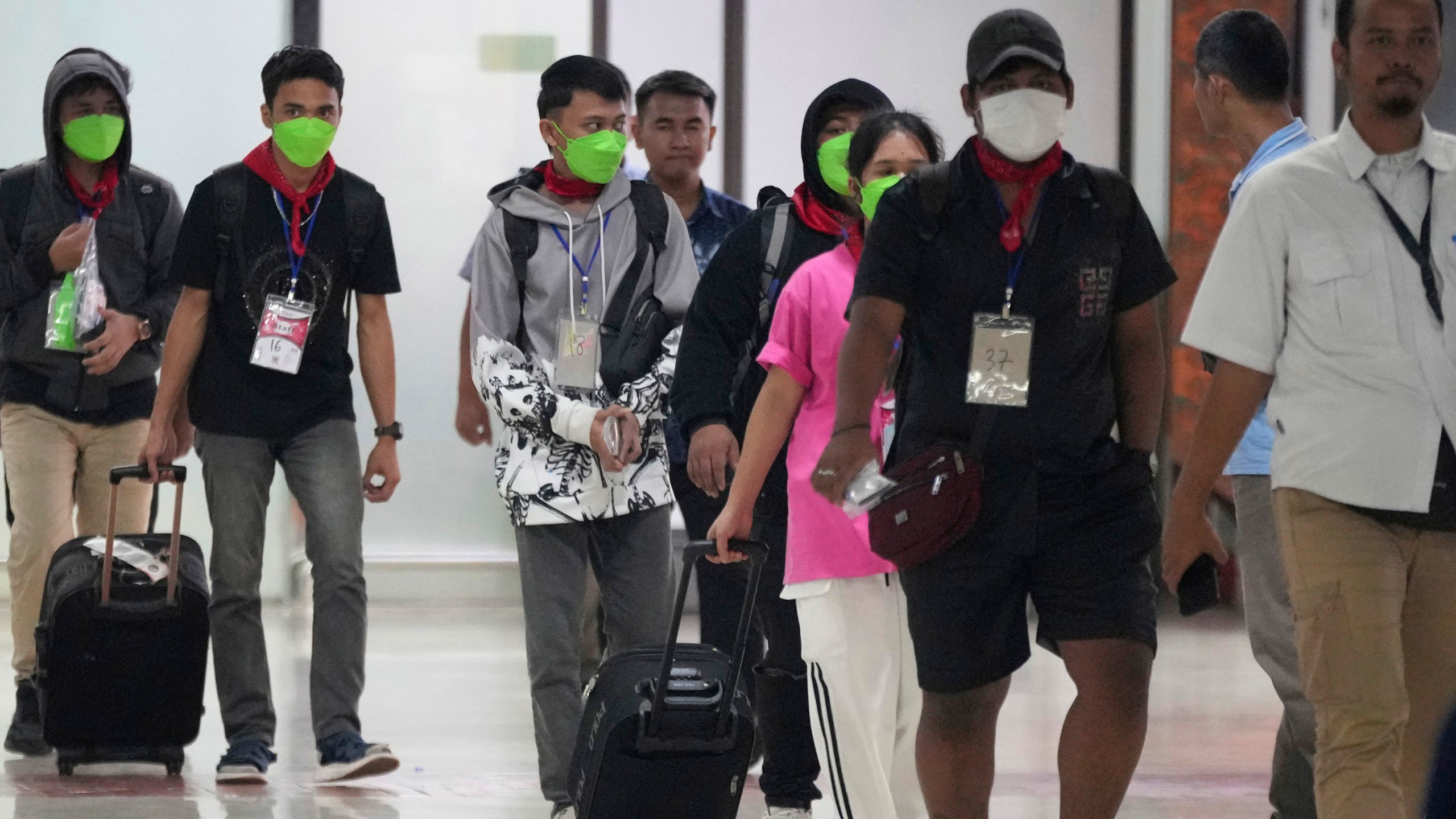 FILE- Indonesians who were forced to work at scam centers in eastern Myanmar arrive at Soekarno-Hatta International Airport in Tangerang, Indonesia, Friday, Feb. 28, 2025.(AP Photo/Tatan Syuflana, File)