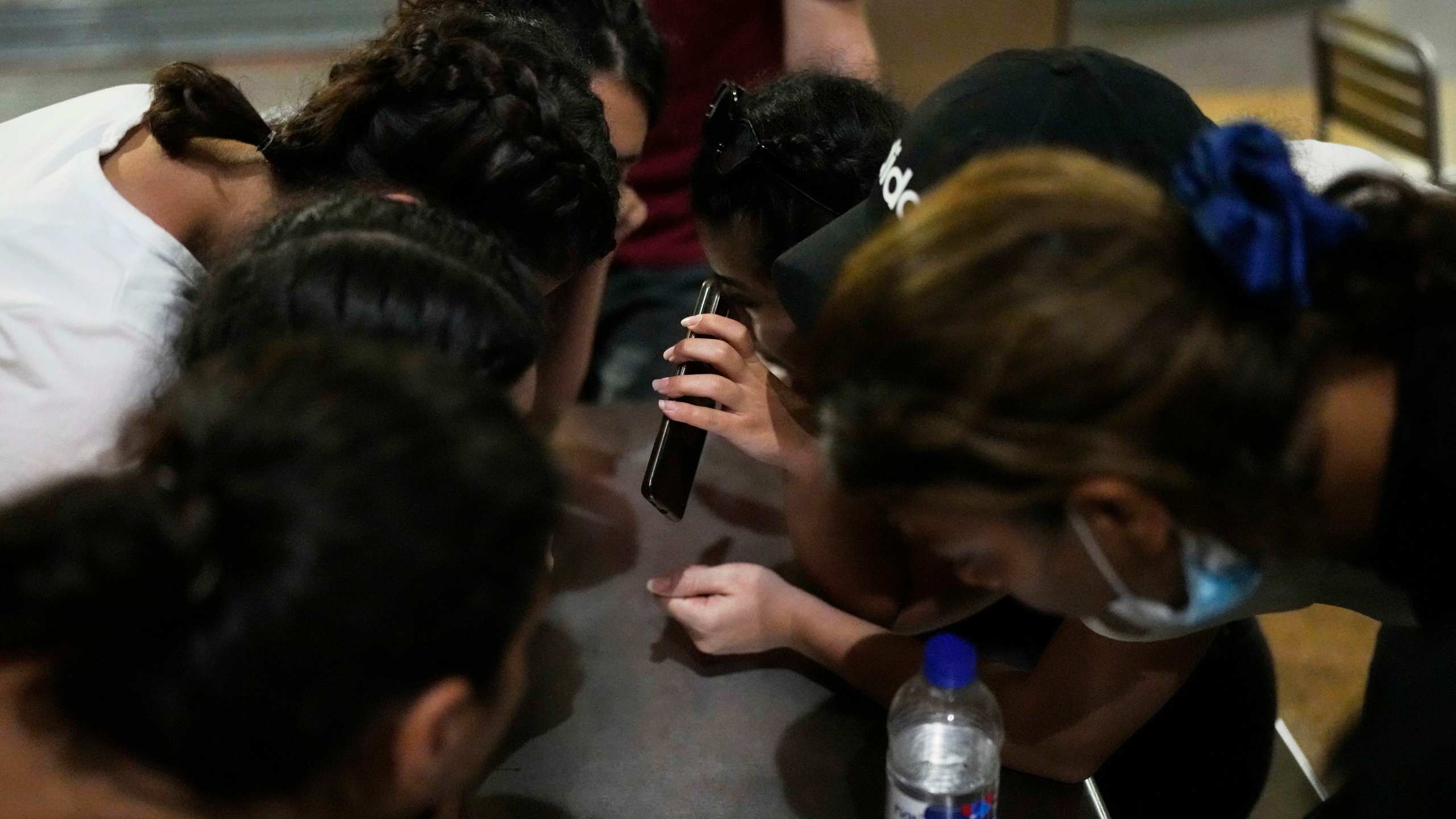 Iranian migrants make a phone call from a bus station food court after arriving in Panama City, Saturday, March 8, 2025, following weeks in a Panamanian immigration camp where they were held after their deportation from the U.S. and released on the condition that they leave the country within 30 days. (AP Photo/Matias Delacroix)