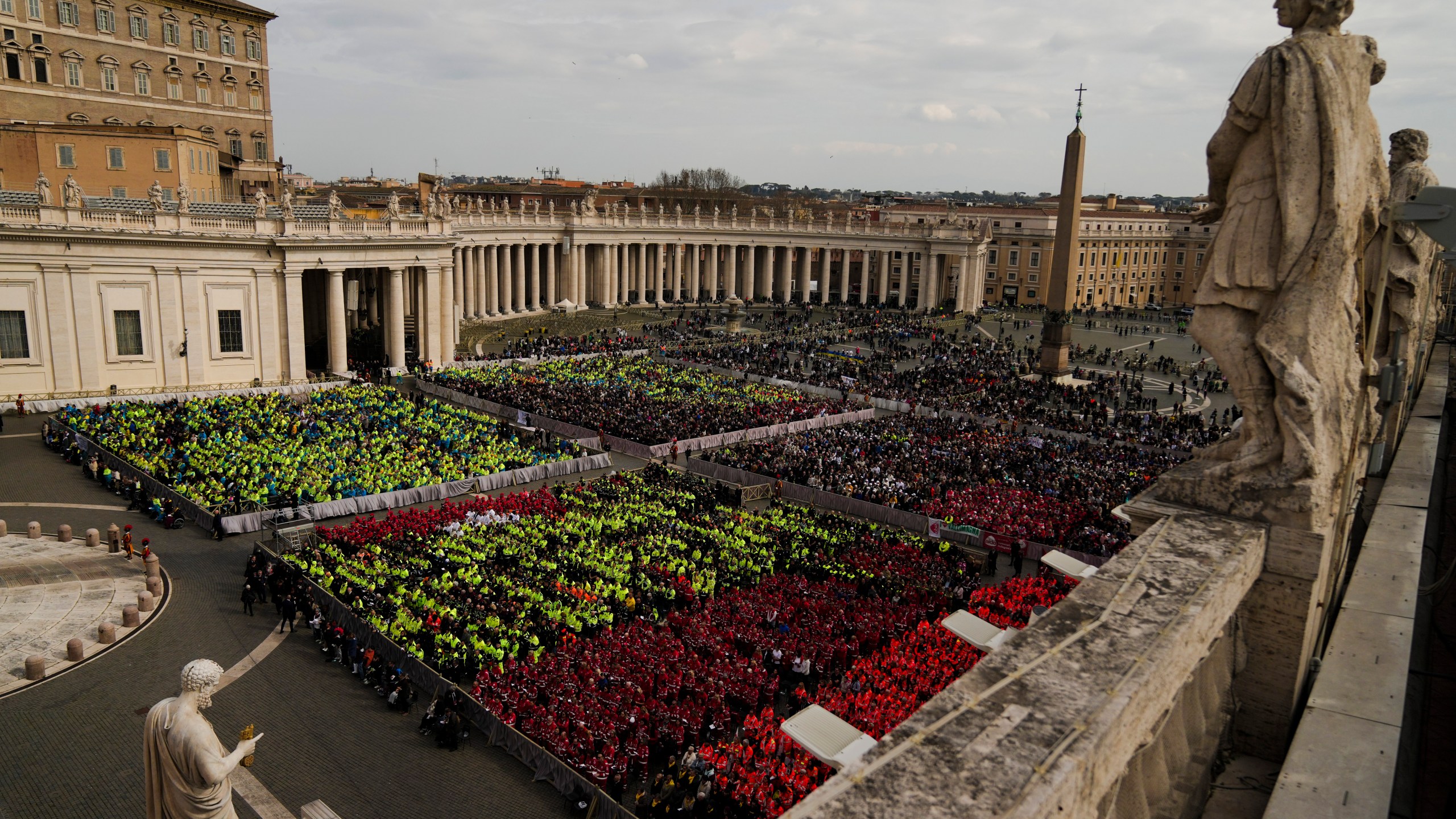 Members of different organizations of volunteers follow Cardinal Michael Czerny, delegate of Pope Francis who is being treated for pneumonia at Rome's Agostino Gemelli Polyclinic, celebrating a mass for the world of volunteers in St. Peter's Square at The Vatican, Sunday, March 9, 2025. (AP Photo/Francisco Seco)