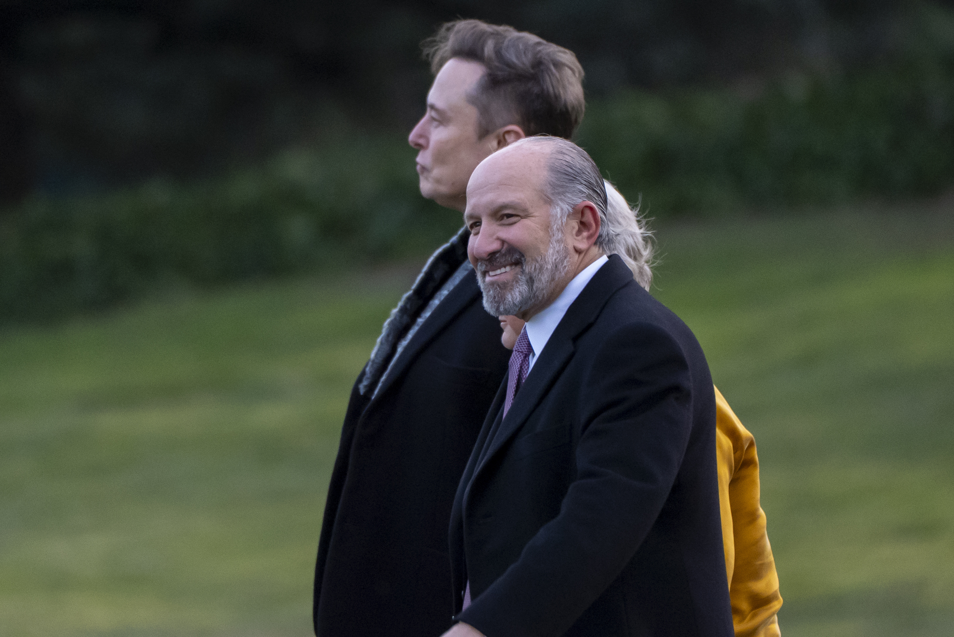 Elon Musk, from left, White House chief of staff Susie Wiles, obstructed, and Commerce Secretary Howard Lutnick walk to join President Donald Trump on Marine One on the South Lawn of the White House, Friday, March 7, 2025, in Washington. (AP Photo/Alex Brandon)