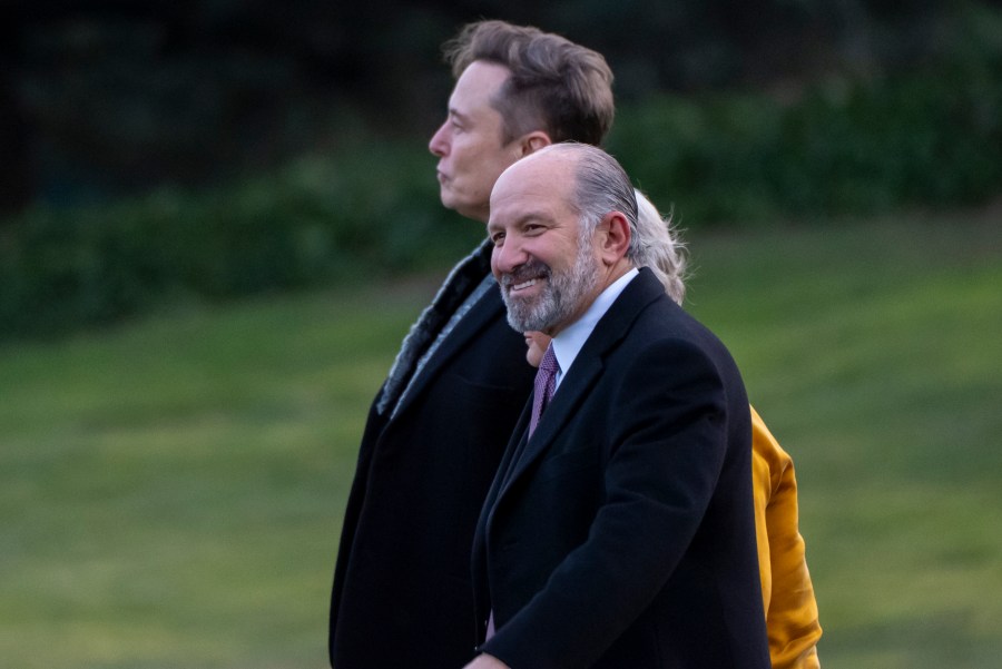 Elon Musk, from left, White House chief of staff Susie Wiles, obstructed, and Commerce Secretary Howard Lutnick walk to join President Donald Trump on Marine One on the South Lawn of the White House, Friday, March 7, 2025, in Washington. (AP Photo/Alex Brandon)