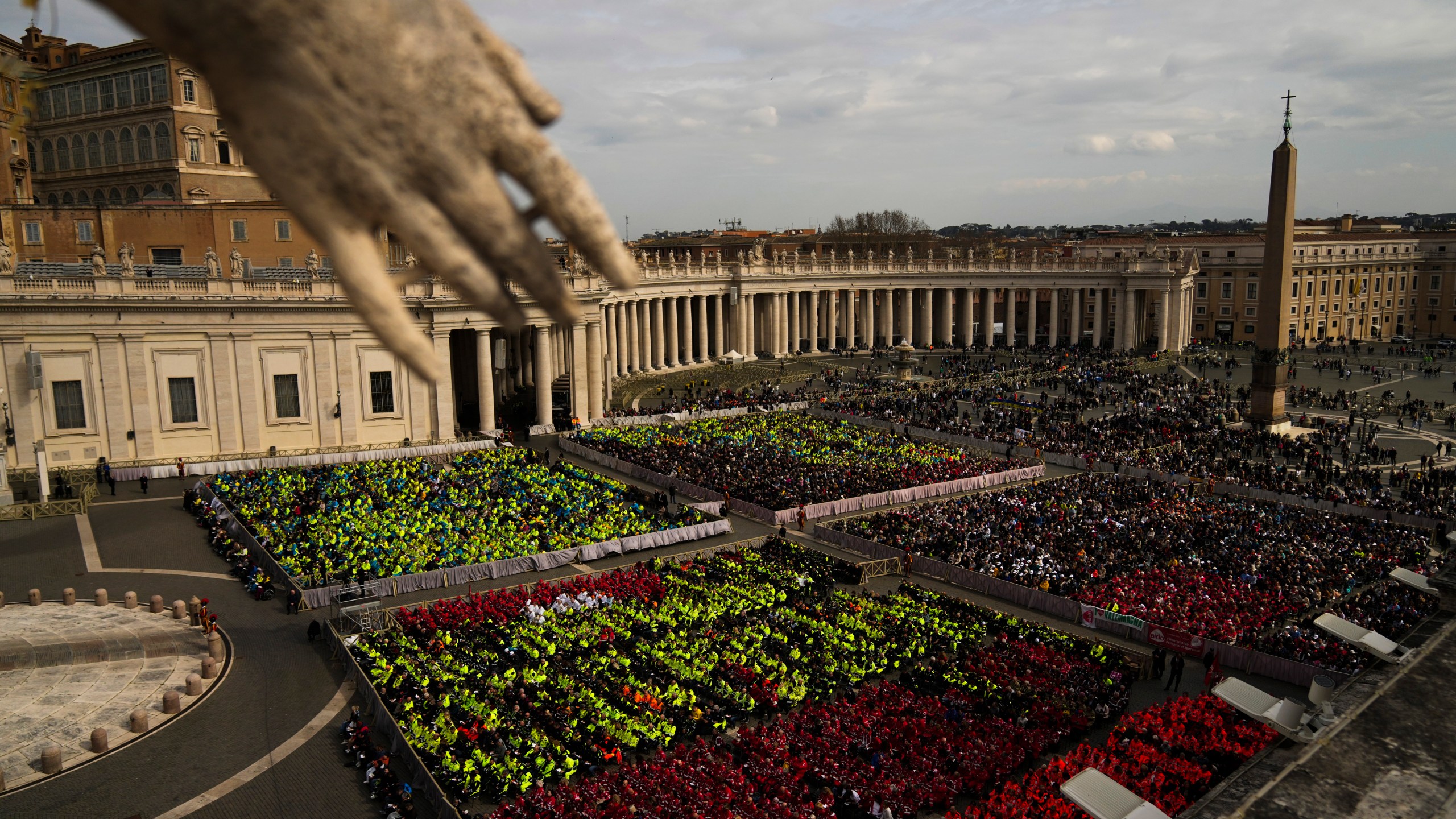 Members of different organizations of volunteers follow Cardinal Michael Czerny, delegate of Pope Francis who is being treated for pneumonia at Rome's Agostino Gemelli Polyclinic, celebrating a mass for the world of volunteers in St. Peter's Square at The Vatican, Sunday, March 9, 2025. (AP Photo/Francisco Seco)