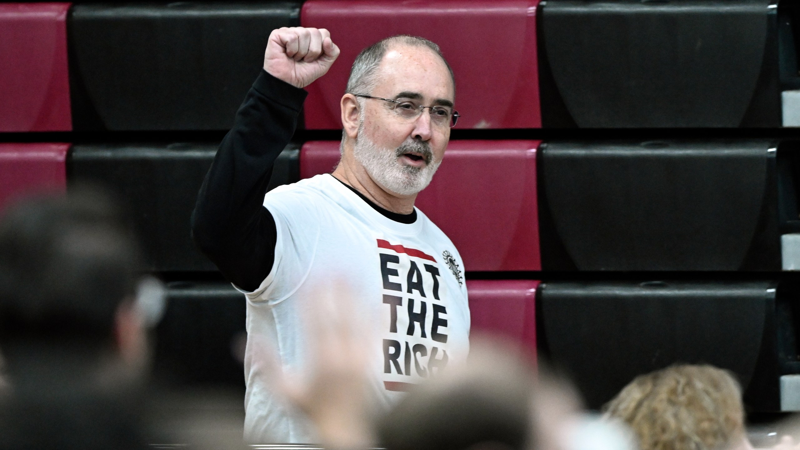 United Auto Workers President Shawn Fain acknowledges the crowd, as he heads to the stage to introduce Sen. Bernie Sanders, I-Vt., during a "Fighting Oligarchy: Where We Go From Here" event Saturday, March 8, 2025, at Lincoln High School in Warren, Mich. (AP Photo/Jose Juarez)