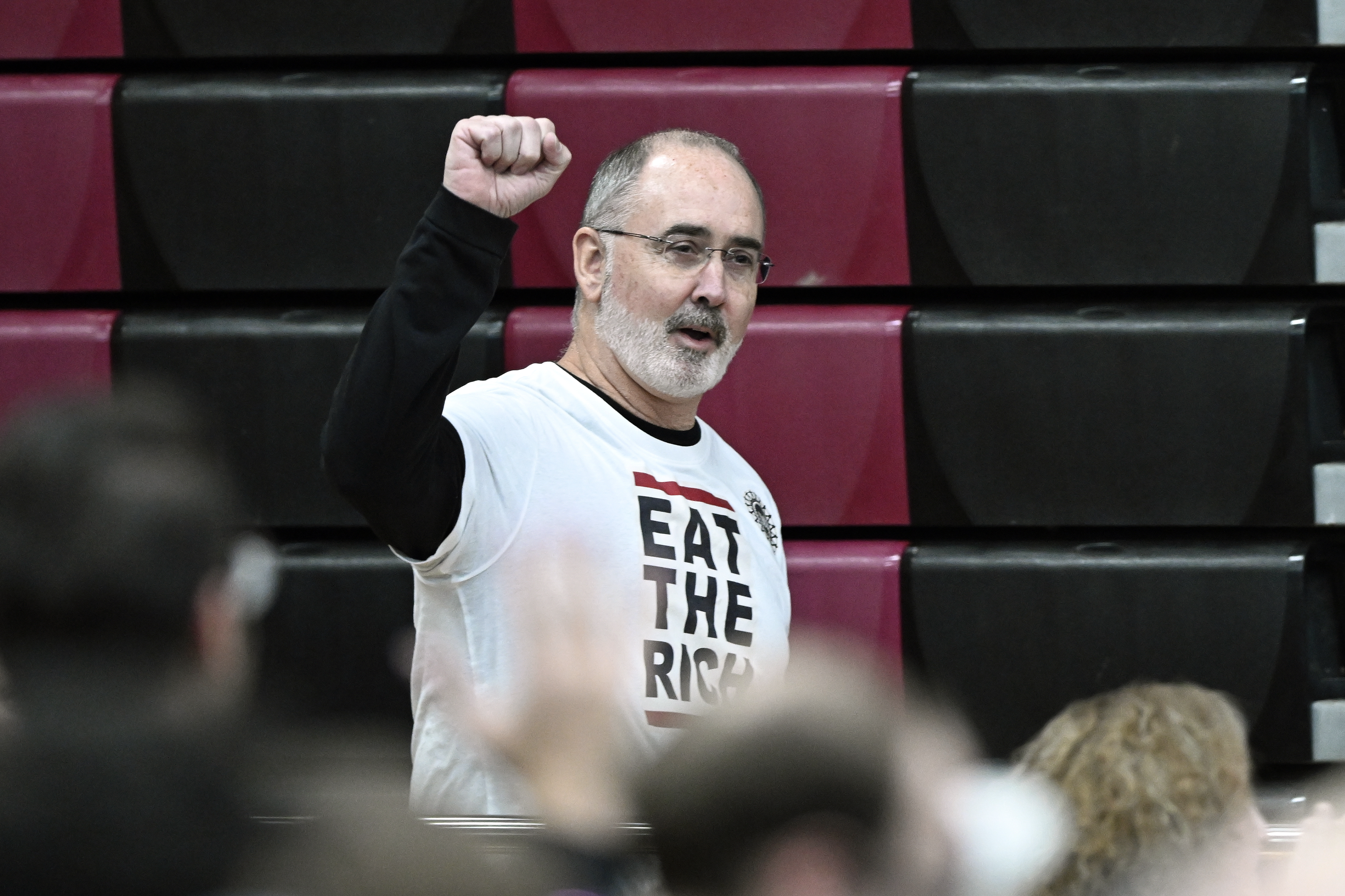 United Auto Workers President Shawn Fain acknowledges the crowd, as he heads to the stage to introduce Sen. Bernie Sanders, I-Vt., during a "Fighting Oligarchy: Where We Go From Here" event Saturday, March 8, 2025, at Lincoln High School in Warren, Mich. (AP Photo/Jose Juarez)