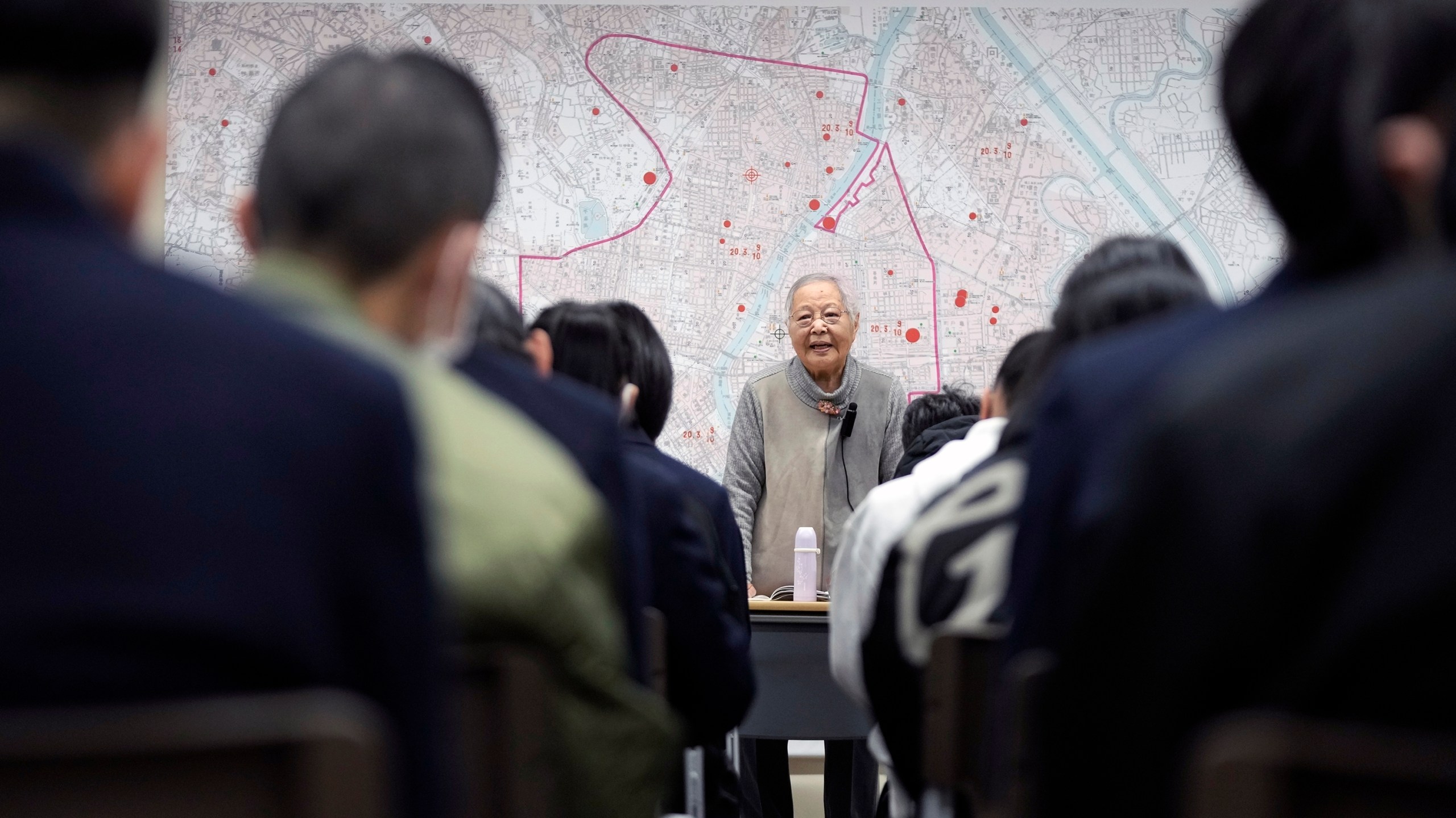 Shizuyo Takeuchi, 94-year-old Tokyo raid survivor, shares her experience in front of a map of the areas damaged during the 1945 Tokyo Firebombing at the Center of the Tokyo Raids and War Damage on Feb. 24, 2025, in Tokyo. (AP Photo/Eugene Hoshiko)