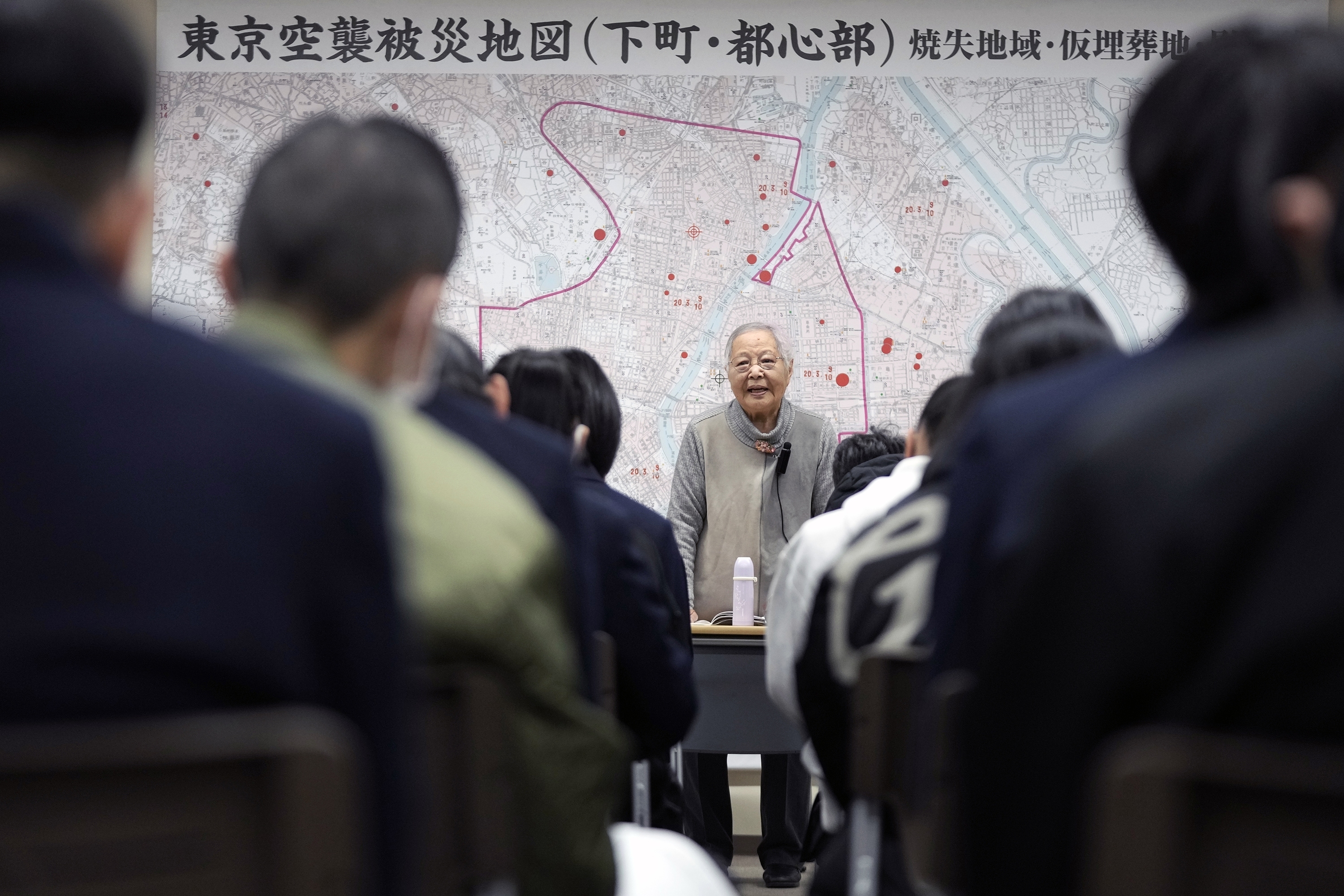 Shizuyo Takeuchi, 94-year-old Tokyo raid survivor, shares her experience in front of a map of the areas damaged during the 1945 Tokyo Firebombing at the Center of the Tokyo Raids and War Damage on Feb. 24, 2025, in Tokyo. (AP Photo/Eugene Hoshiko)