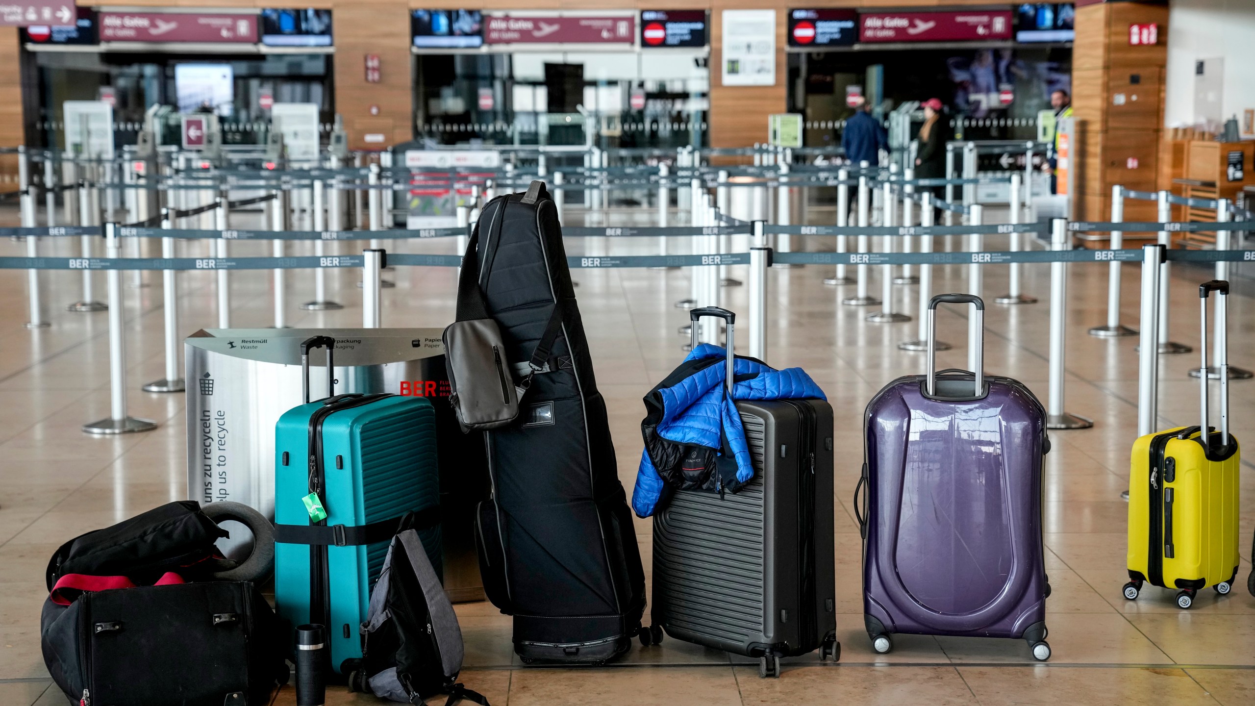 Passengers' luggage is on the floor at the Berlin-Brandenburg airport, during the airports warning strike, Germany, Monday, March 10, 2025. (AP Photo/Ebrahim Noroozi)