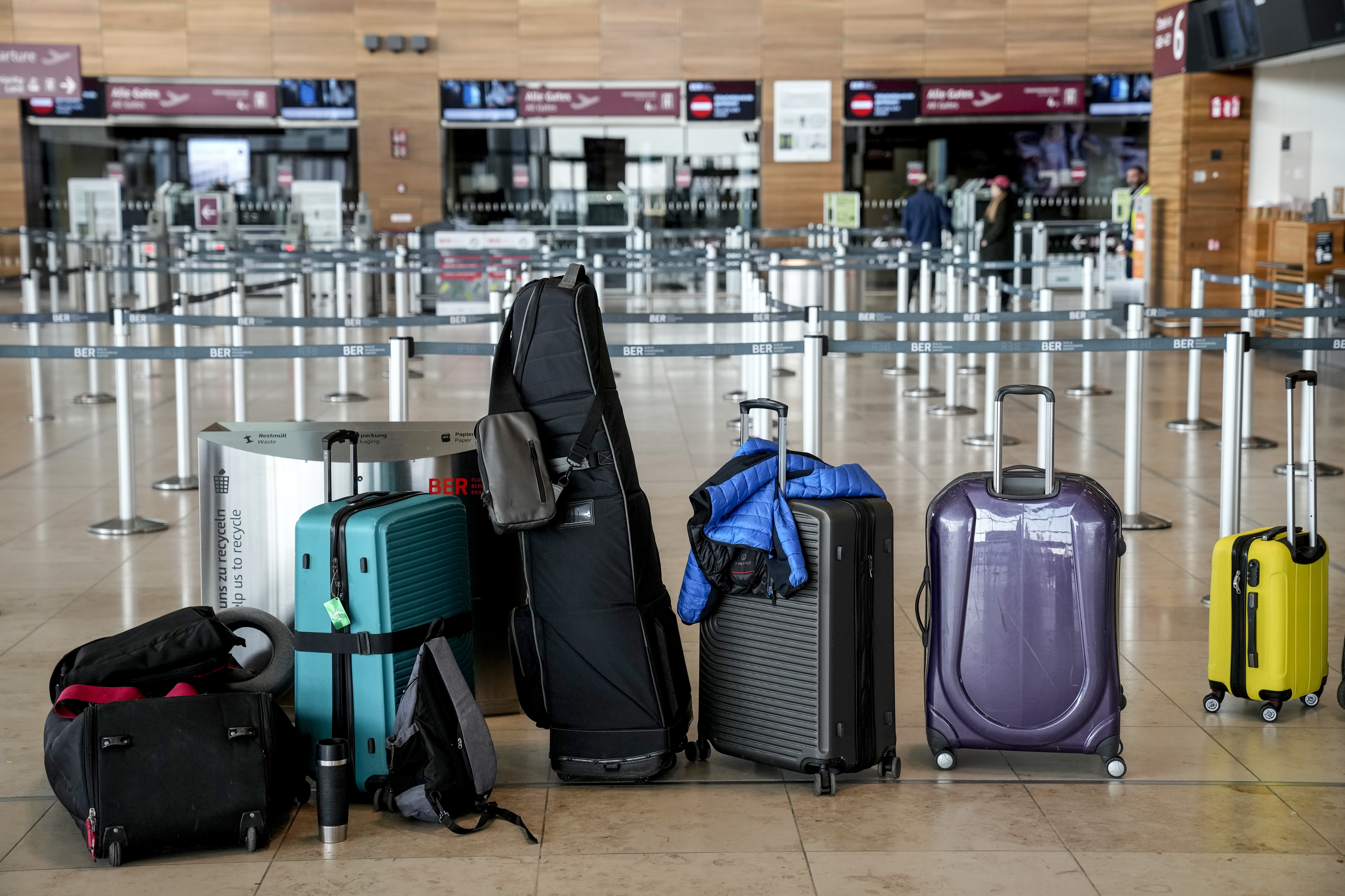 Passengers' luggage is on the floor at the Berlin-Brandenburg airport, during the airports warning strike, Germany, Monday, March 10, 2025. (AP Photo/Ebrahim Noroozi)