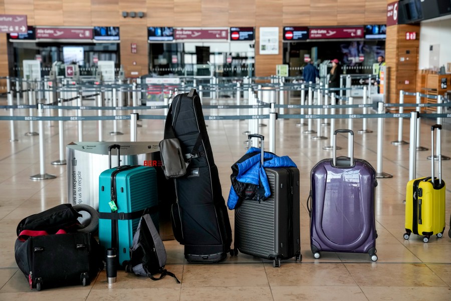 Passengers' luggage is on the floor at the Berlin-Brandenburg airport, during the airports warning strike, Germany, Monday, March 10, 2025. (AP Photo/Ebrahim Noroozi)