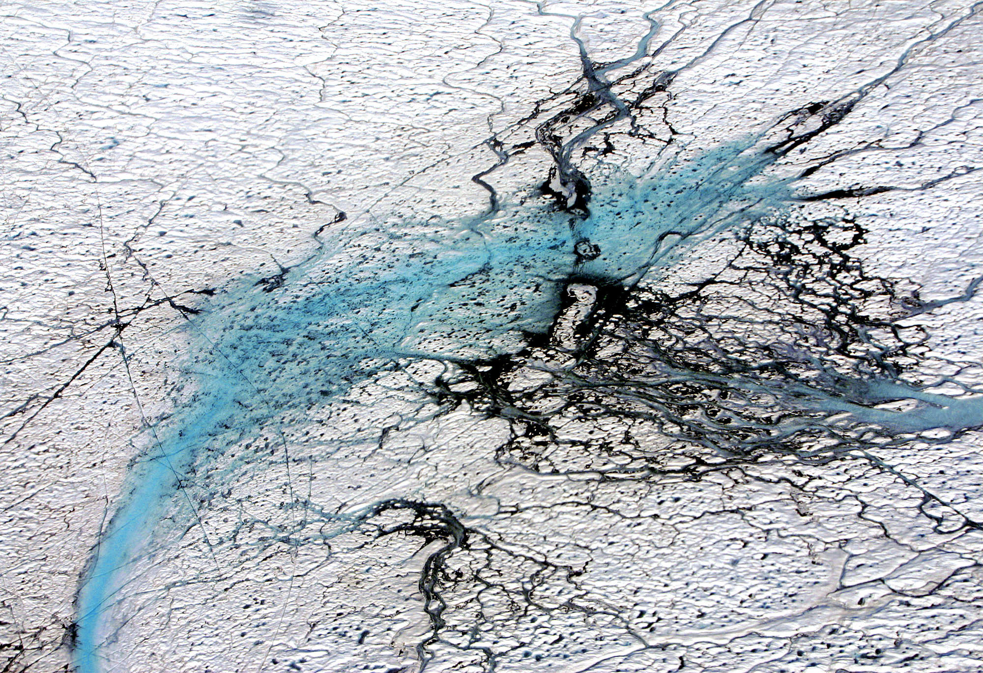 FILE - Varying shades of blue rivers meander through the Greenland ice cap in this aerial photograph from August 2005. (AP Photo/John McConnico, file)