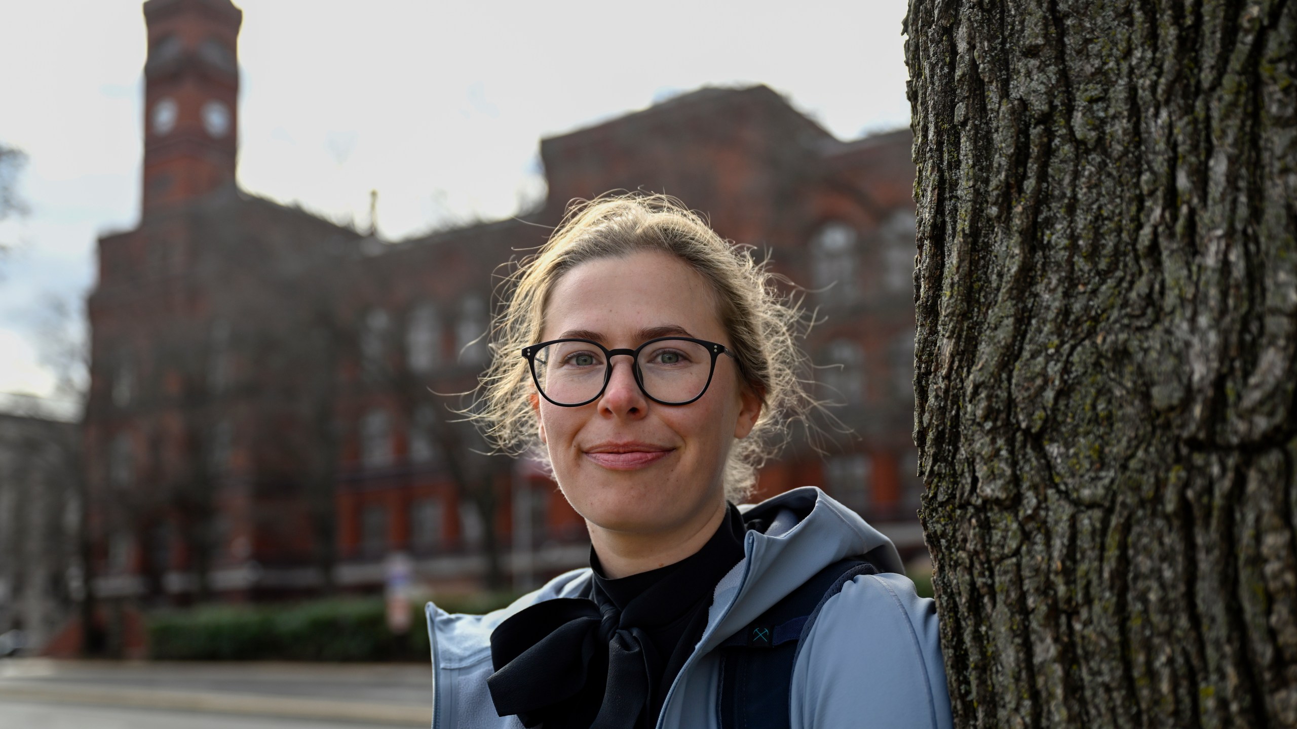 Sydney Smith, who lost her job due to DOGE cuts, stands in front of the Sydney Yates building that houses the Forest Service on Thursday, March. 6, 2025, in Washington. (AP Photo/John McDonnell)